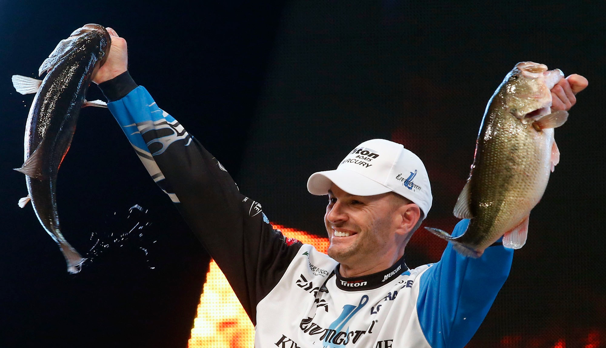 Randy Howell, Springville, Ala., holds up two bass at a weigh-in, Sunday Feb. 23, 2014 in Birmingham, Ala. that helped him win the Bassmaster Classic on Lake Guntersville. (AP Photo/Hal Yeager)