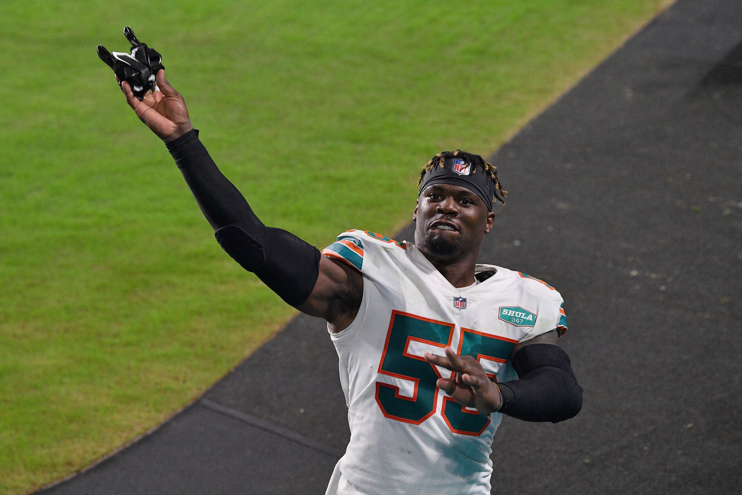 MIAMI GARDENS, FLORIDA - NOVEMBER 15: Jerome Baker #55 of the Miami Dolphins throws his game gloves to the fans after the game against the Los Angeles Chargers at Hard Rock Stadium on November 15, 2020 in Miami Gardens, Florida. (Photo by Mark Brown/Getty Images)