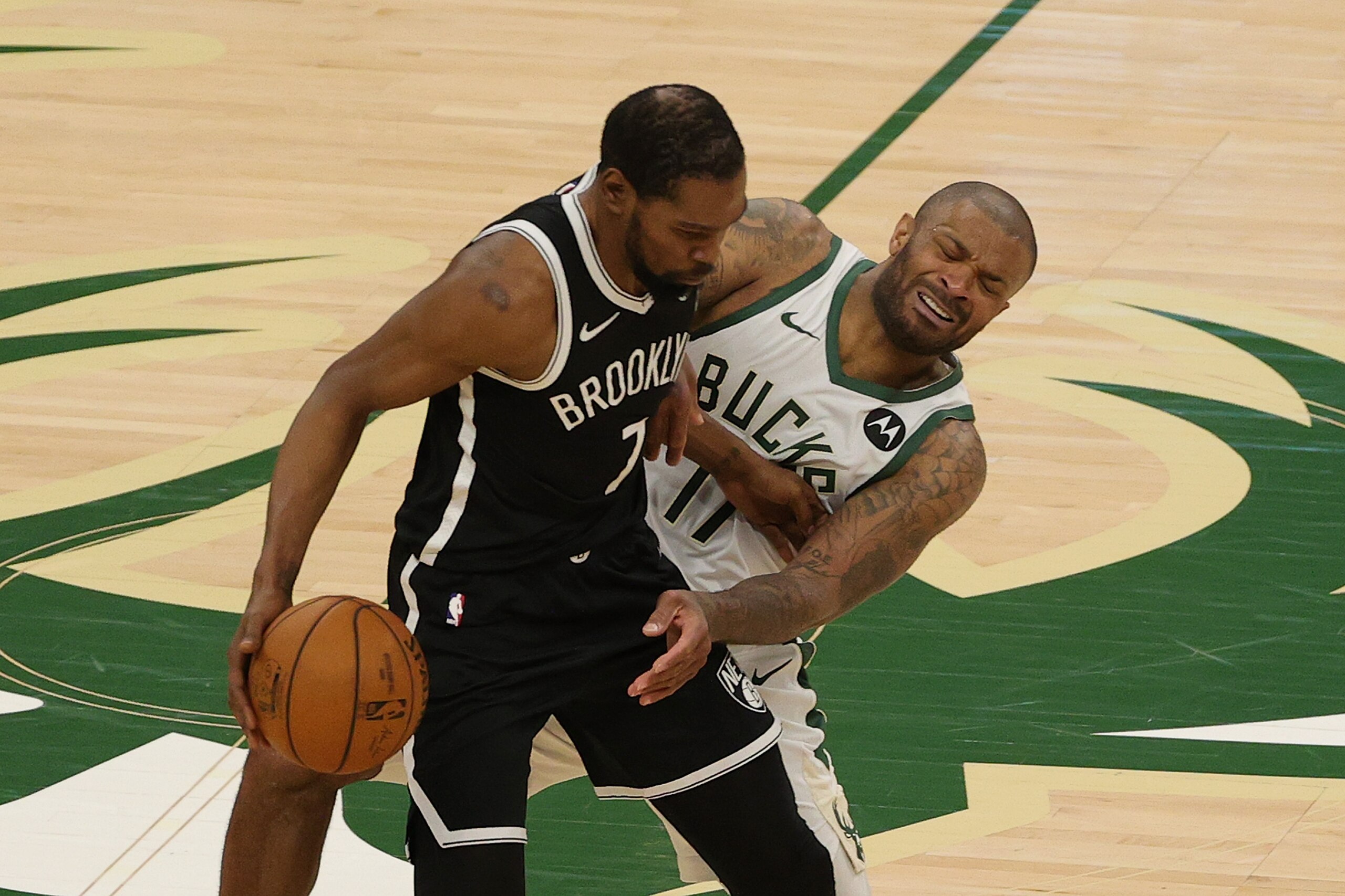 MILWAUKEE, WISCONSIN - JUNE 13: Kevin Durant #7 of the Brooklyn Nets is defended by P.J. Tucker #17 of the Milwaukee Bucks during the second half of Game Four of the Eastern Conference second round playoff series at the Fiserv Forum on June 13, 2021 in Milwaukee, Wisconsin. NOTE TO USER: User expressly acknowledges and agrees that, by downloading and or using this photograph, User is consenting to the terms and conditions of the Getty Images License Agreement. (Photo by Stacy Revere/Getty Images)
