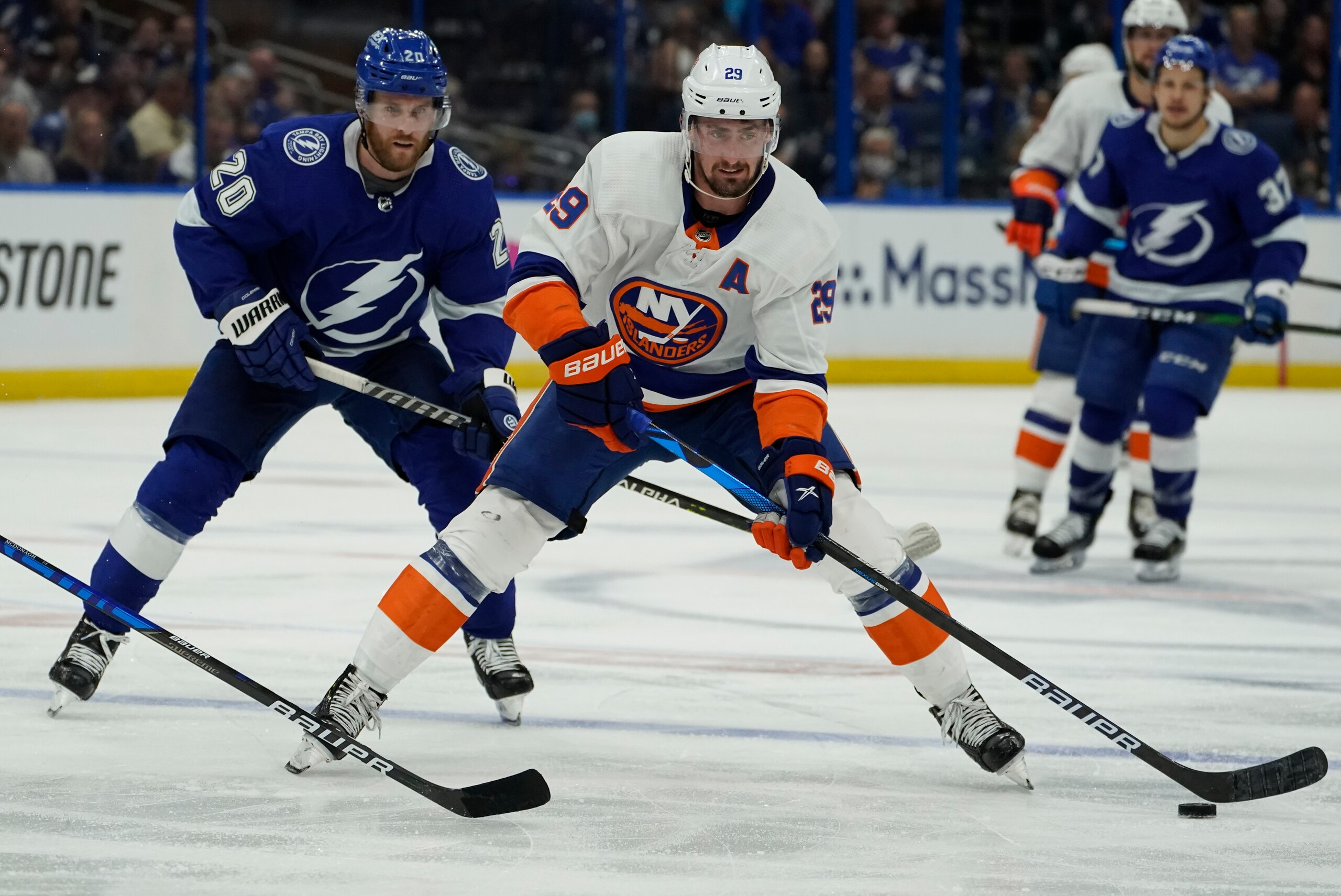 New York Islanders center Brock Nelson (29) moves the pu8ck in front of Tampa Bay Lightning center Blake Coleman (20) during the third period in Game 1 of an NHL hockey Stanley Cup semifinal playoff series Sunday, June 13, 2021, in Tampa, Fla. (AP Photo/Chris O'Meara) New York Islanders center Brock Nelson (29) moves the pu8ck in front of Tampa Bay Lightning center Blake Coleman (20) during the third period in Game 1 of an NHL hockey Stanley Cup semifinal playoff series Sunday, June 13, 2021, in Tampa, Fla. (AP Photo/Chris O'Meara)
