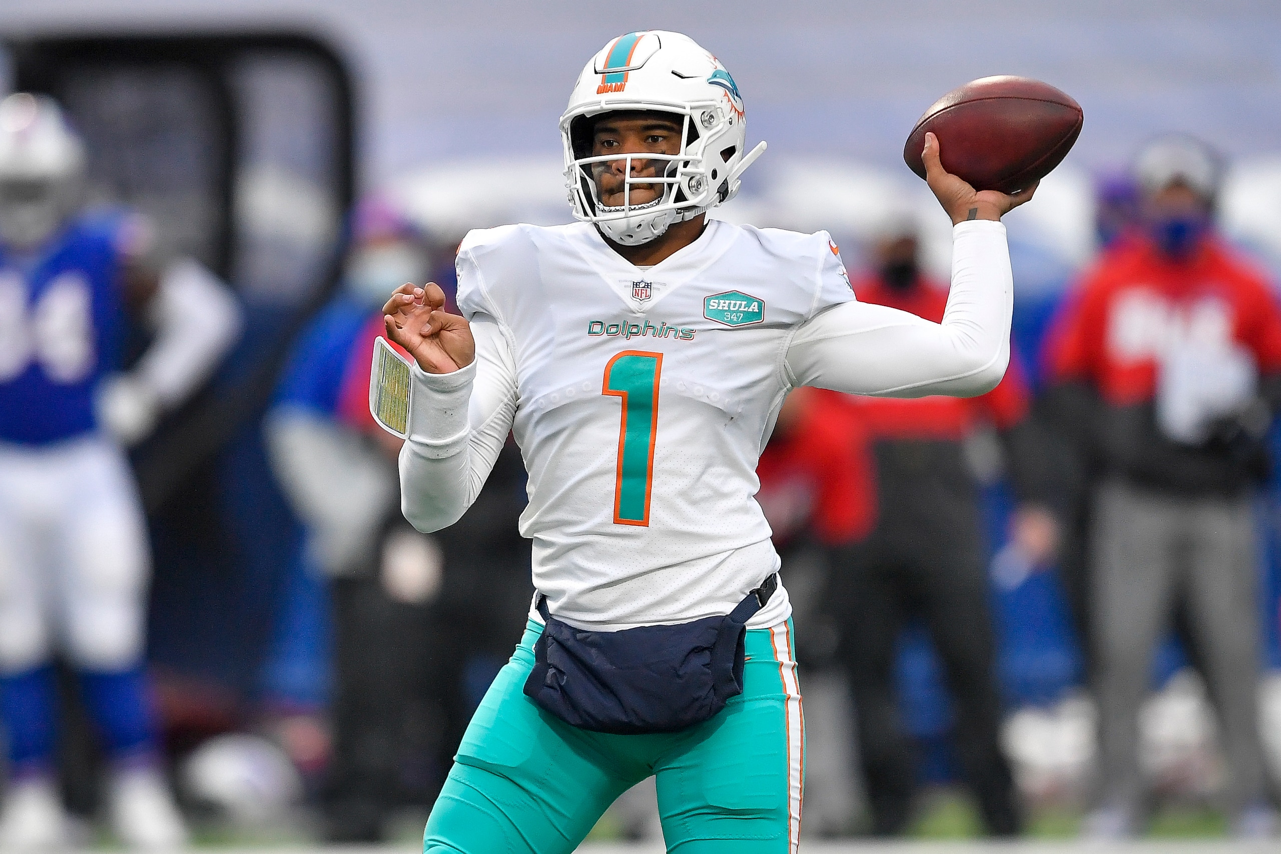 FILE - In this Jan. 3, 2021, file photo, Miami Dolphins quarterback Tua Tagovailoa (1) throws a pass during the second half of an NFL football game against the Buffalo Bills in Orchard Park, N.Y. The Dolphins have already been busy in the draft, even though it has not started yet. They have made three trades involving their top selection, moves motivated by Miami's desire to stockpile picks without giving up the chance to acquire a playmaking target for Tagovailoa. (AP Photo/Adrian Kraus, File)