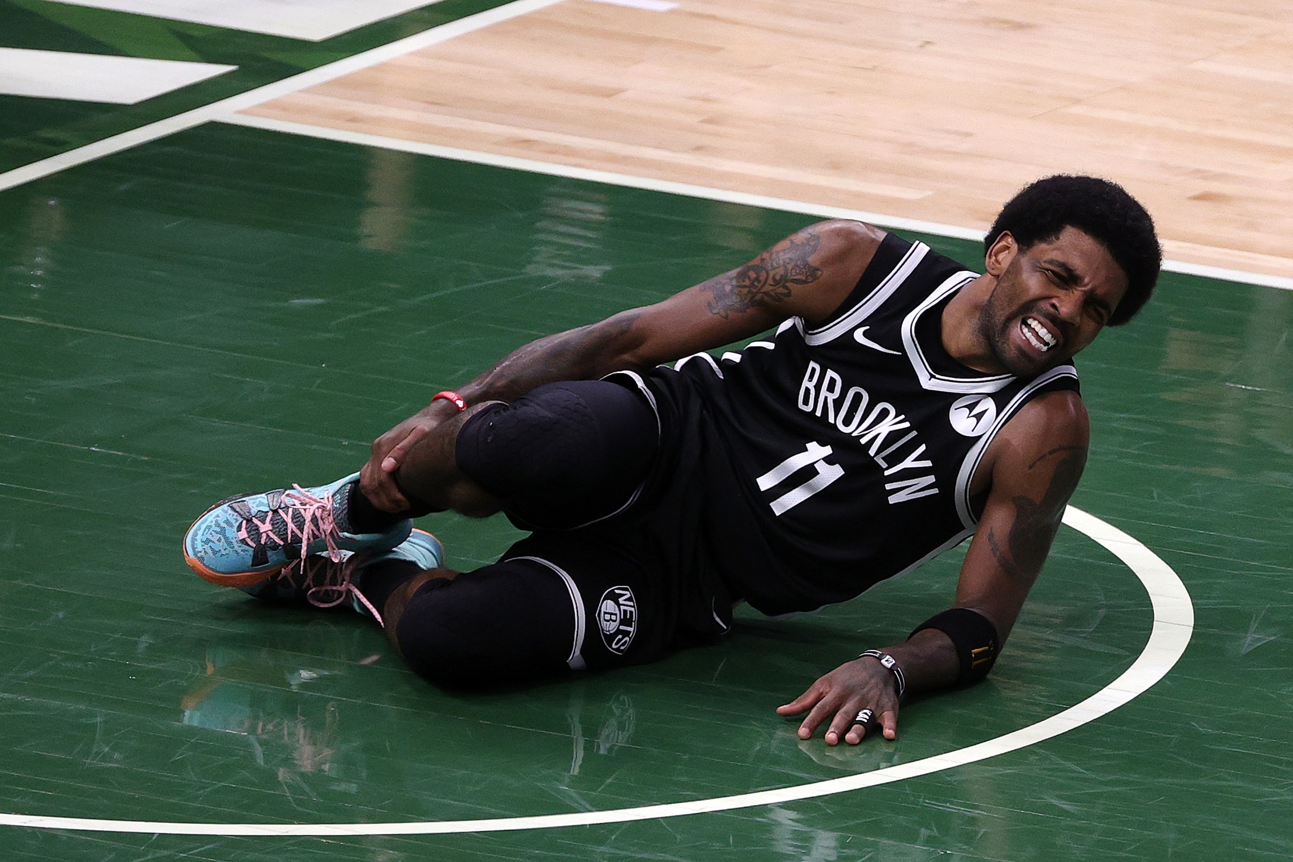 MILWAUKEE, WISCONSIN - JUNE 13: Kyrie Irving #11 of the Brooklyn Nets is injured during the first half of Game Four of the Eastern Conference second round playoff series against the Milwaukee Bucks at the Fiserv Forum on June 13, 2021 in Milwaukee, Wisconsin. NOTE TO USER: User expressly acknowledges and agrees that, by downloading and or using this photograph, User is consenting to the terms and conditions of the Getty Images License Agreement. (Photo by Stacy Revere/Getty Images)
