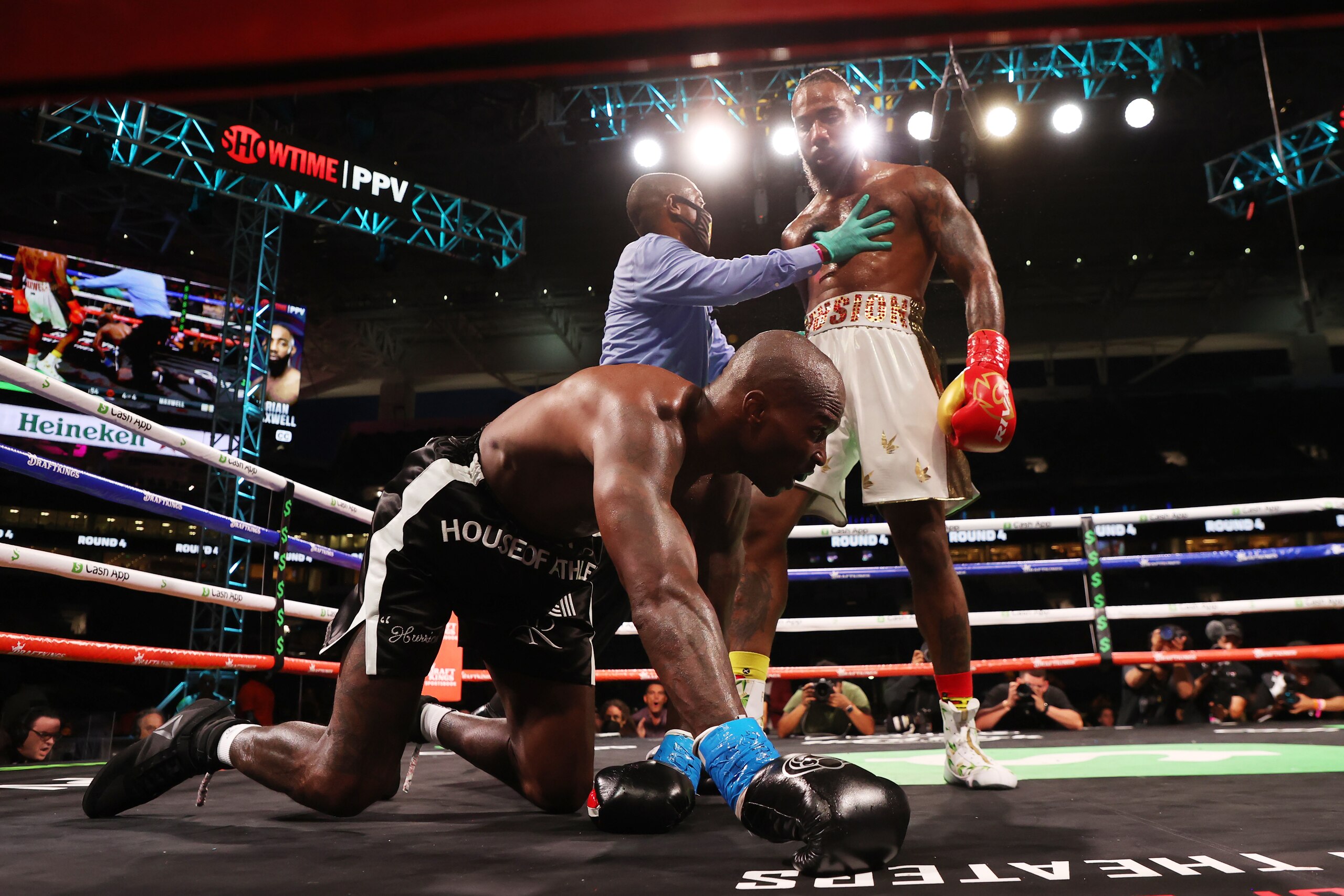 MIAMI GARDENS, FLORIDA - JUNE 06: Chad Johnson is knocked down by Brian Maxwell during their contracted exhibition boxing match at Hard Rock Stadium on June 06, 2021 in Miami Gardens, Florida. (Photo by Cliff Hawkins/Getty Images)
