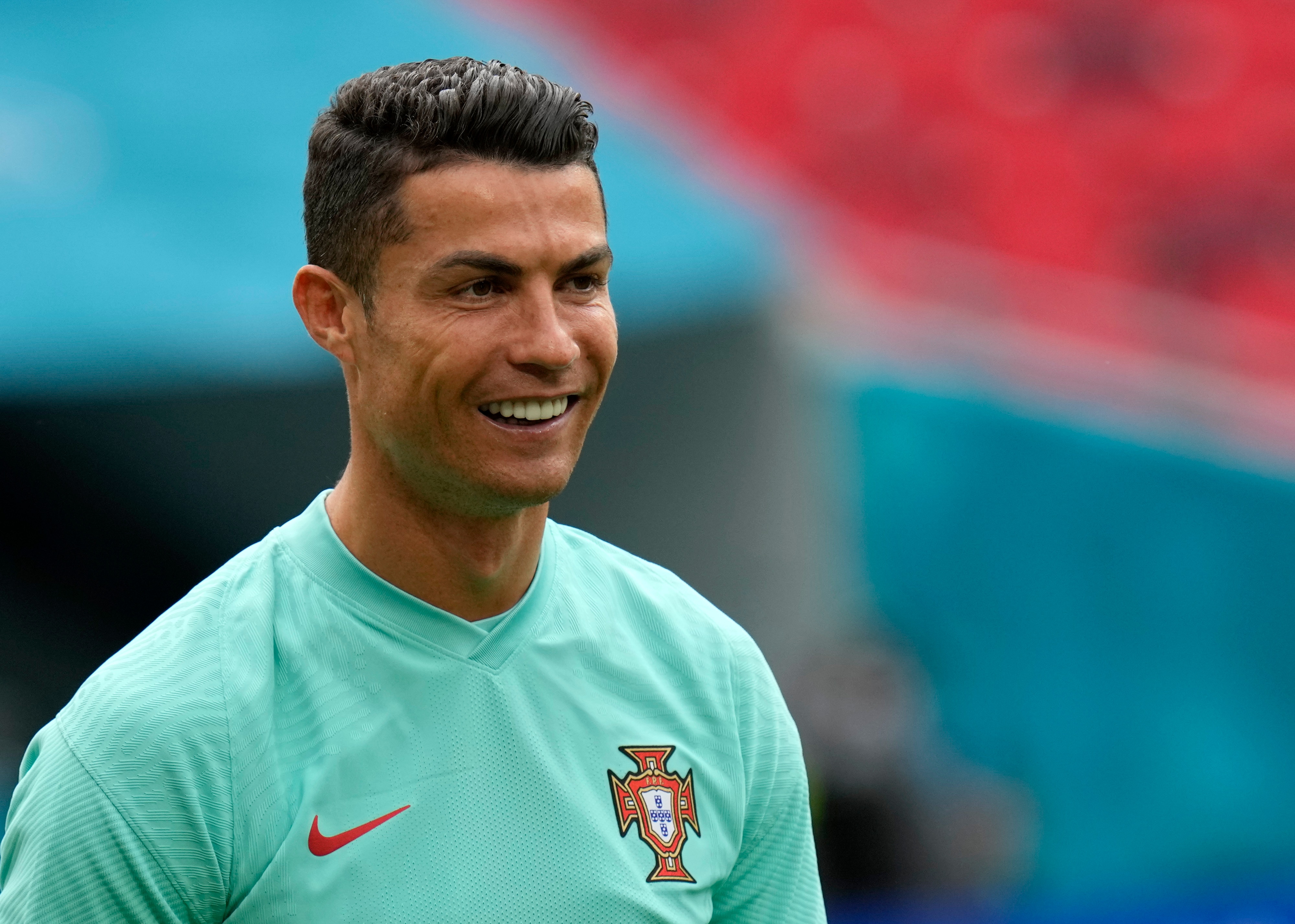 Portugal's Cristiano Ronaldo smiles during a team training session at the Ferenc Puskas stadium in Budapest, Monday, June 14, 2021 the day before the Euro 2020 soccer championship group F match between Hungary and Portugal. (AP Photo/Darko Bandic)