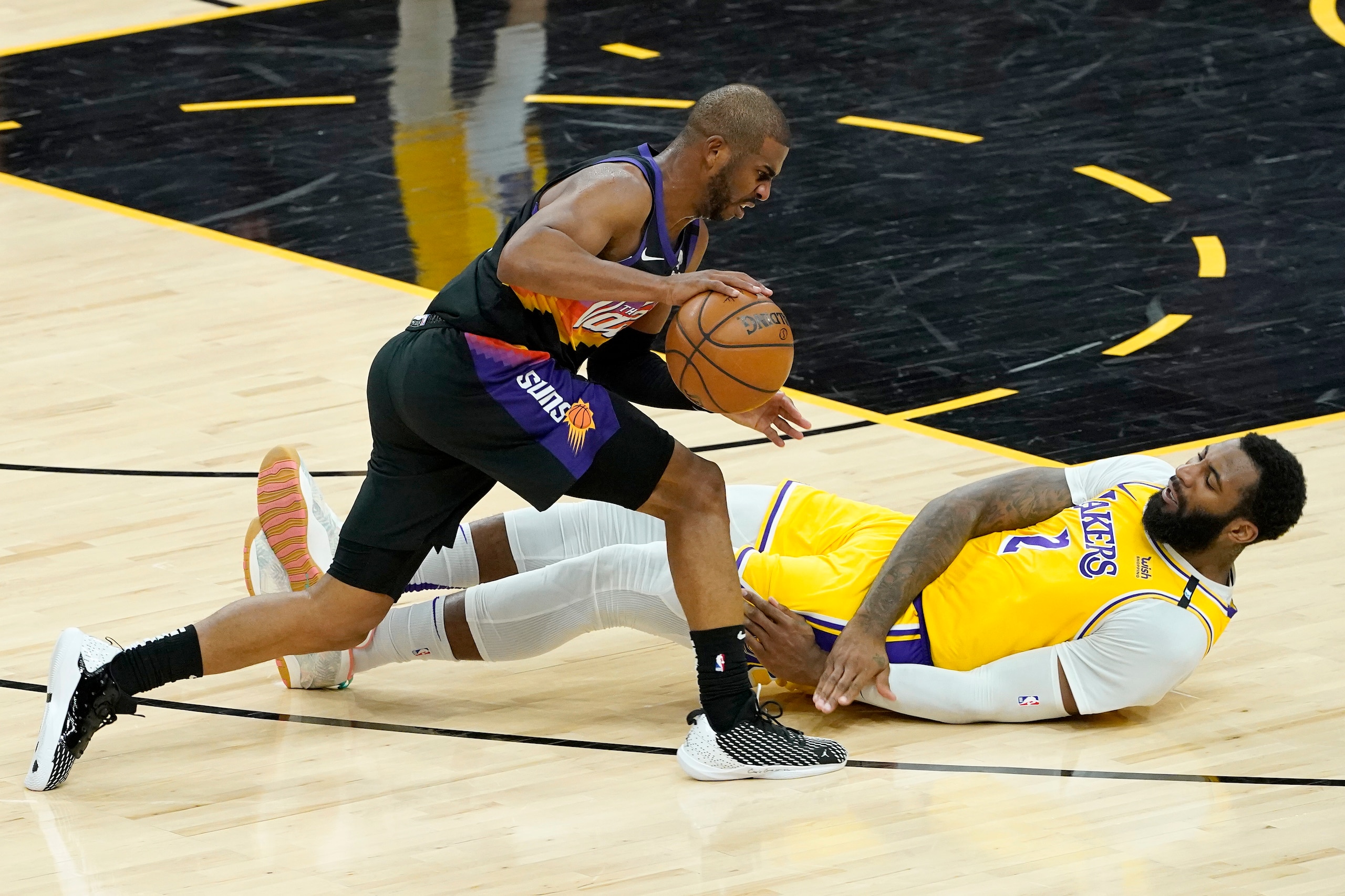 Los Angeles Lakers center Andre Drummond (2) falls as Phoenix Suns guard Chris Paul (3) drives during the first half of Game 5 of an NBA basketball first-round playoff series, Tuesday, June 1, 2021, in Phoenix. (AP Photo/Matt York) Los Angeles Lakers center Andre Drummond (2) falls as Phoenix Suns guard Chris Paul (3) drives during the first half of Game 5 of an NBA basketball first-round playoff series, Tuesday, June 1, 2021, in Phoenix. (AP Photo/Matt York)