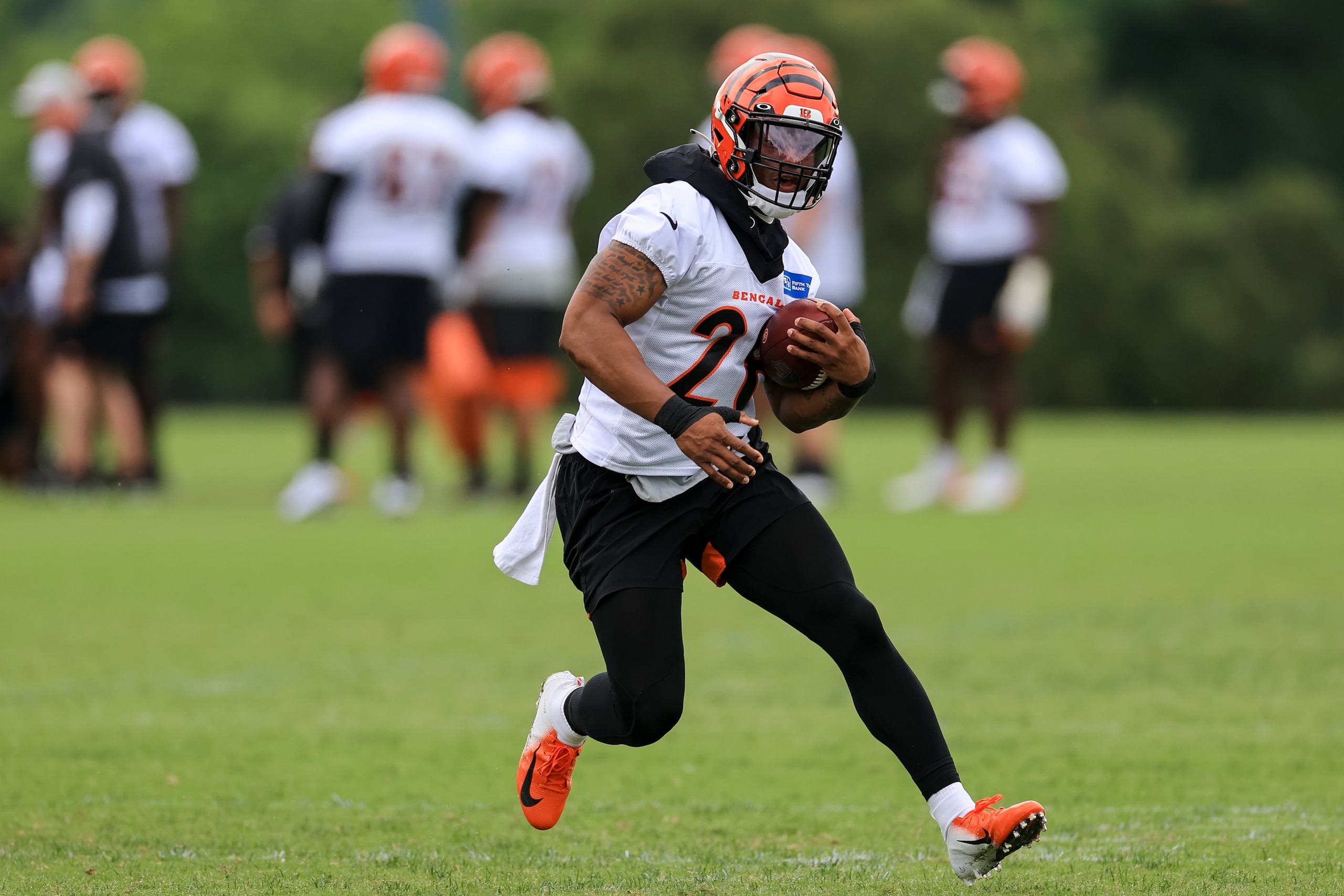 Cincinnati Bengals' Joe Mixon carries the ball during an NFL football camp practice in Cincinnati, Tuesday, June 8, 2021. (AP Photo/Aaron Doster)