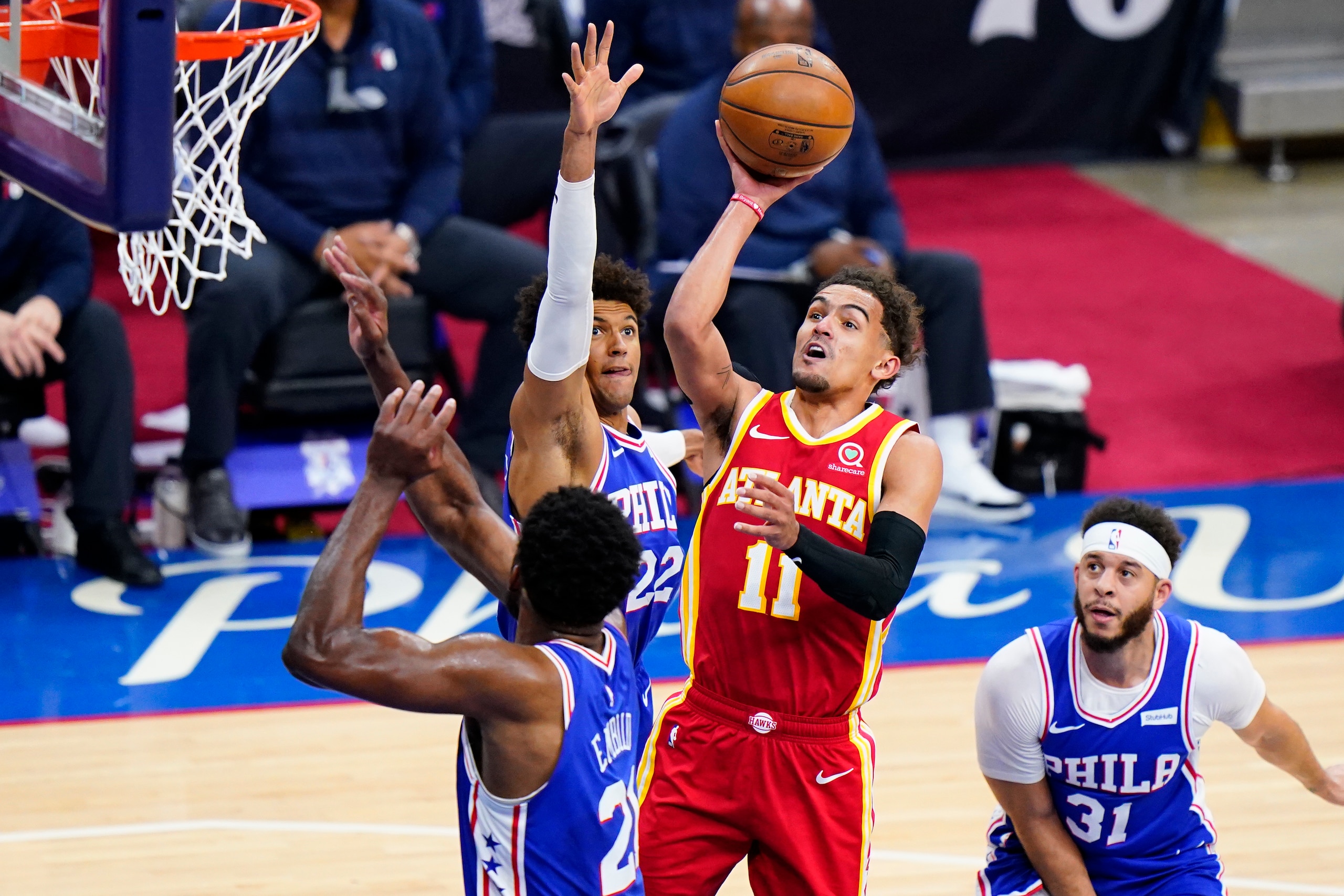 Atlanta Hawks' Trae Young (11) goes up for a shot against Philadelphia 76ers' Joel Embiid (21), Matisse Thybulle (22) and Seth Curry (31) during the second half of Game 5 in a second-round NBA basketball playoff series, Wednesday, June 16, 2021, in Philadelphia. (AP Photo/Matt Slocum)