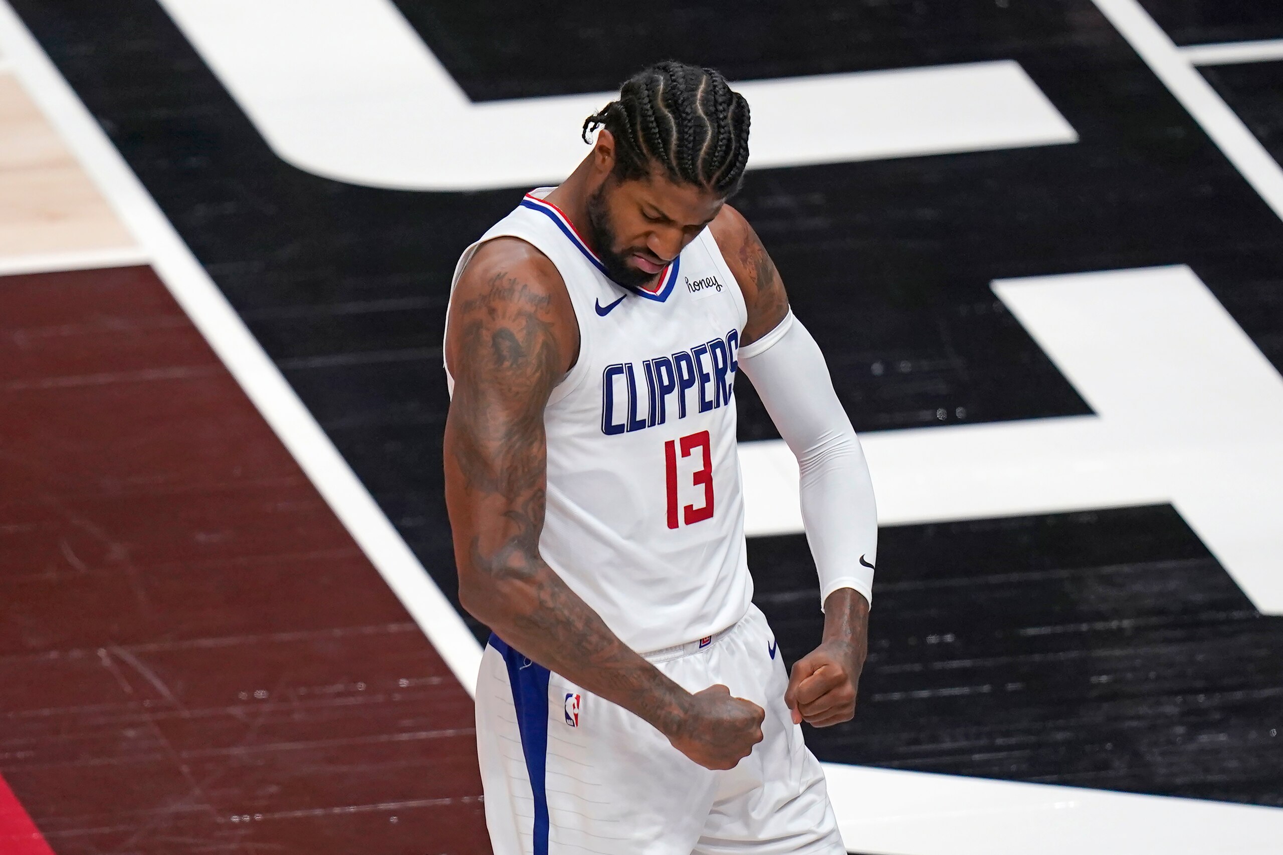 Los Angeles Clippers guard Paul George (13) flexes his muscles after scoring against the Utah Jazz during the first half of Game 5 of a second-round NBA basketball playoff series Wednesday, June 16, 2021, in Salt Lake City. (AP Photo/Rick Bowmer) Los Angeles Clippers guard Paul George (13) flexes his muscles after scoring against the Utah Jazz during the first half of Game 5 of a second-round NBA basketball playoff series Wednesday, June 16, 2021, in Salt Lake City. (AP Photo/Rick Bowmer)