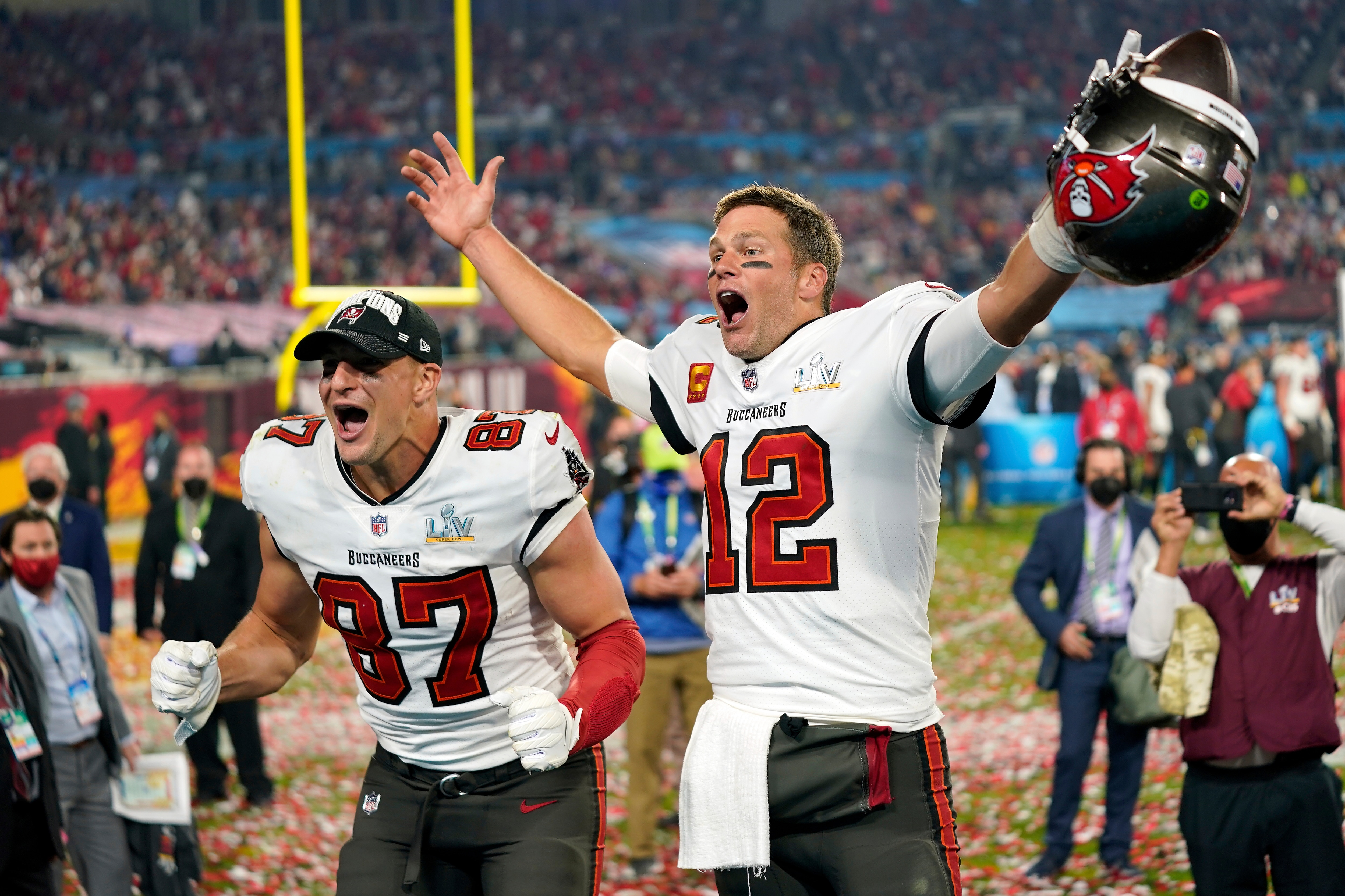 FILE - In this Sunday, Feb. 7, 2021 file photo, Tampa Bay Buccaneers tight end Rob Gronkowski (87), left, and Tampa Bay Buccaneers quarterback Tom Brady (12) celebrate together after the NFL Super Bowl 55 football game against the Kansas City Chiefs in Tampa, Fla. NFL Films has been chronicling Tom Brady’s career since he entered the league in 2000, but there are still times when there are still new things to reveal. That is the case with this year’s Super Bowl film, chronicling Brady’s seventh championship and his first with the Tampa Buccaneers.  (AP Photo/Steve Luciano, File)
