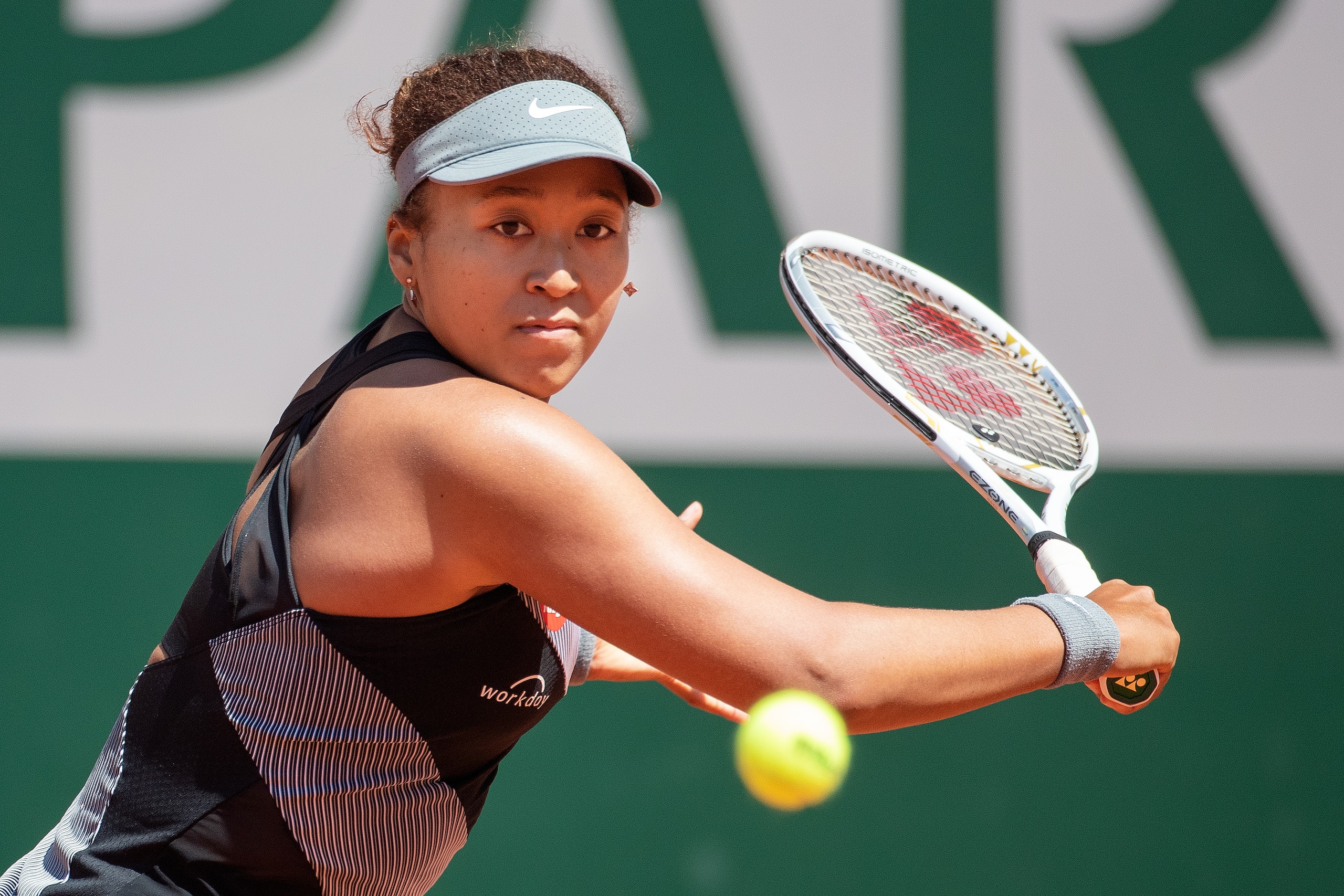 PARIS, FRANCE May 30. Naomi Osaka of Japan in action against Patricia Maria Tig of Romania in the first round of the Women's Singles competition on Court Philippe-Chatrier at the 2021 French Open Tennis Tournament at Roland Garros on May 30th 2021 in Paris, France. (Photo by Tim Clayton/Corbis via Getty Images) PARIS, FRANCE May 30. Naomi Osaka of Japan in action against Patricia Maria Tig of Romania in the first round of the Women's Singles competition on Court Philippe-Chatrier at the 2021 French Open Tennis Tournament at Roland Garros on May 30th 2021 in Paris, France. (Photo by Tim Clayton/Corbis via Getty Images)