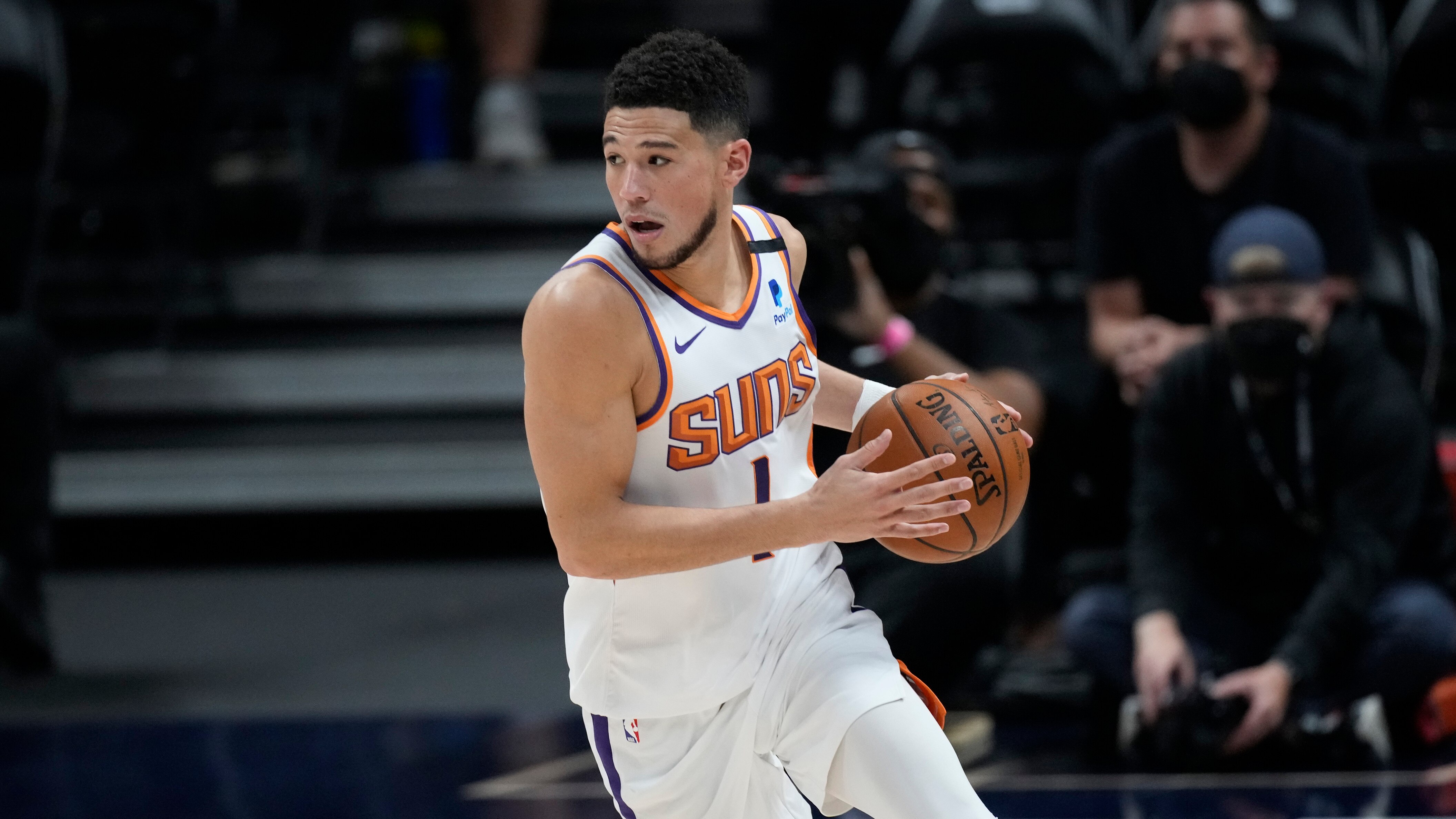 Phoenix Suns guard Devin Booker (1) in the first half of Game 4 of an NBA second-round playoff series Sunday, June 13, 2021, in Denver. (AP Photo/David Zalubowski)