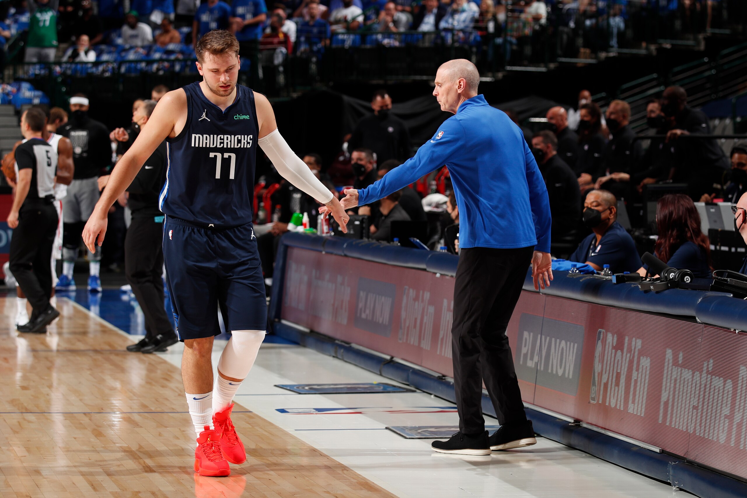 DALLAS, TX - MAY 28: Luka Doncic #77 of the Dallas Mavericks hi-fives Head Coach Rick Carlisle of the Dallas Mavericks during the game against the LA Clippers during Round 1, Game 3 of the 2021 NBA Playoffs on May 28, 2021 at the American Airlines Center in Dallas, Texas. NOTE TO USER: User expressly acknowledges and agrees that, by downloading and or using this photograph, User is consenting to the terms and conditions of the Getty Images License Agreement. Mandatory Copyright Notice: Copyright 2021 NBAE (Photo by Jeff Haynes/NBAE via Getty Images)