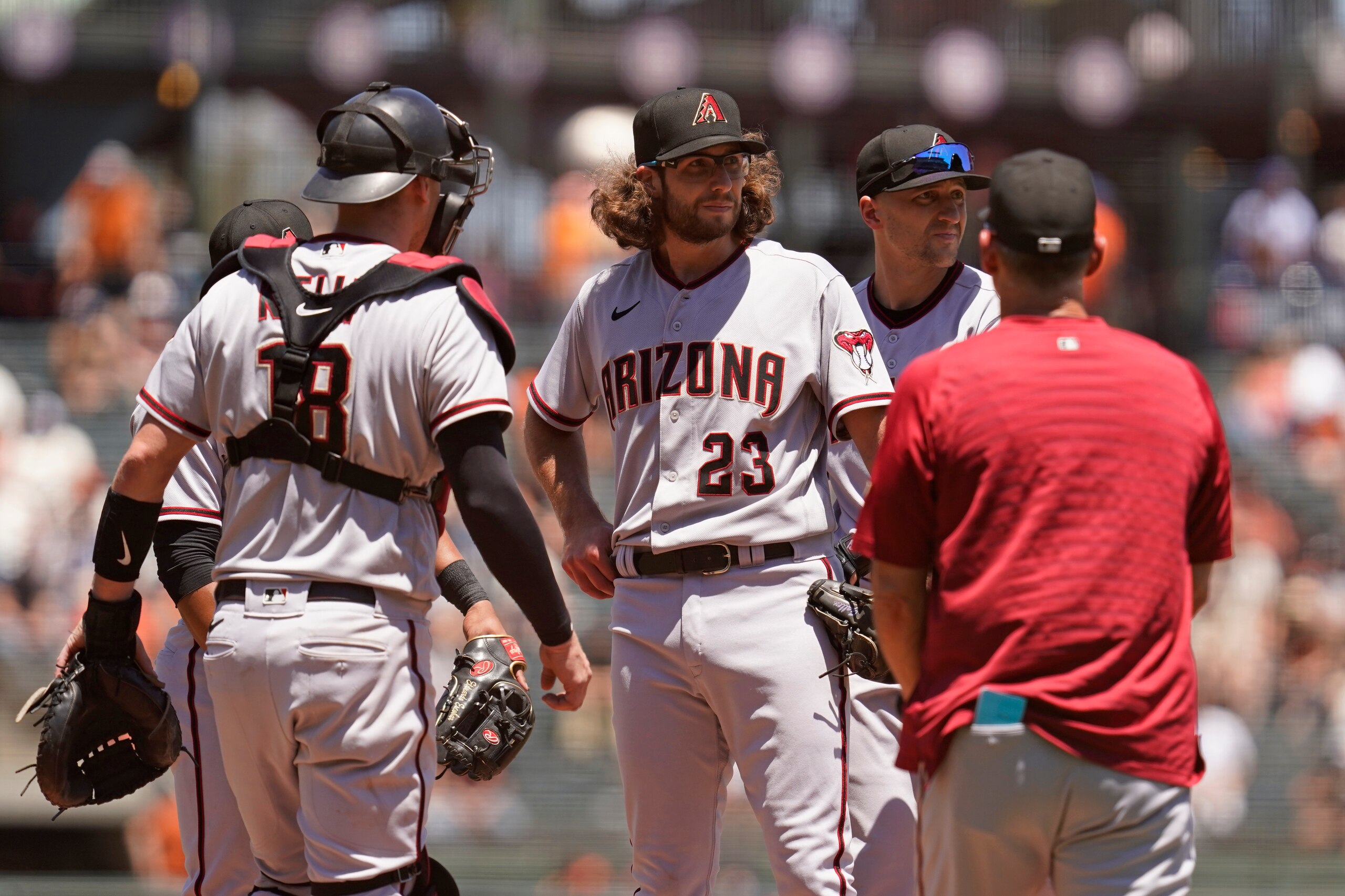 Arizona Diamondbacks starting pitcher Zac Gallen (23) stands on the mound before being removed by manager Torey Lovullo, right, in the third inning of a baseball game against the San Francisco Giants, Thursday, June 17, 2021, in San Francisco. Diamondbacks catcher Carson Kelly, left, and shortstop Nick Ahmed, second from right, look on. (AP Photo/Eric Risberg)