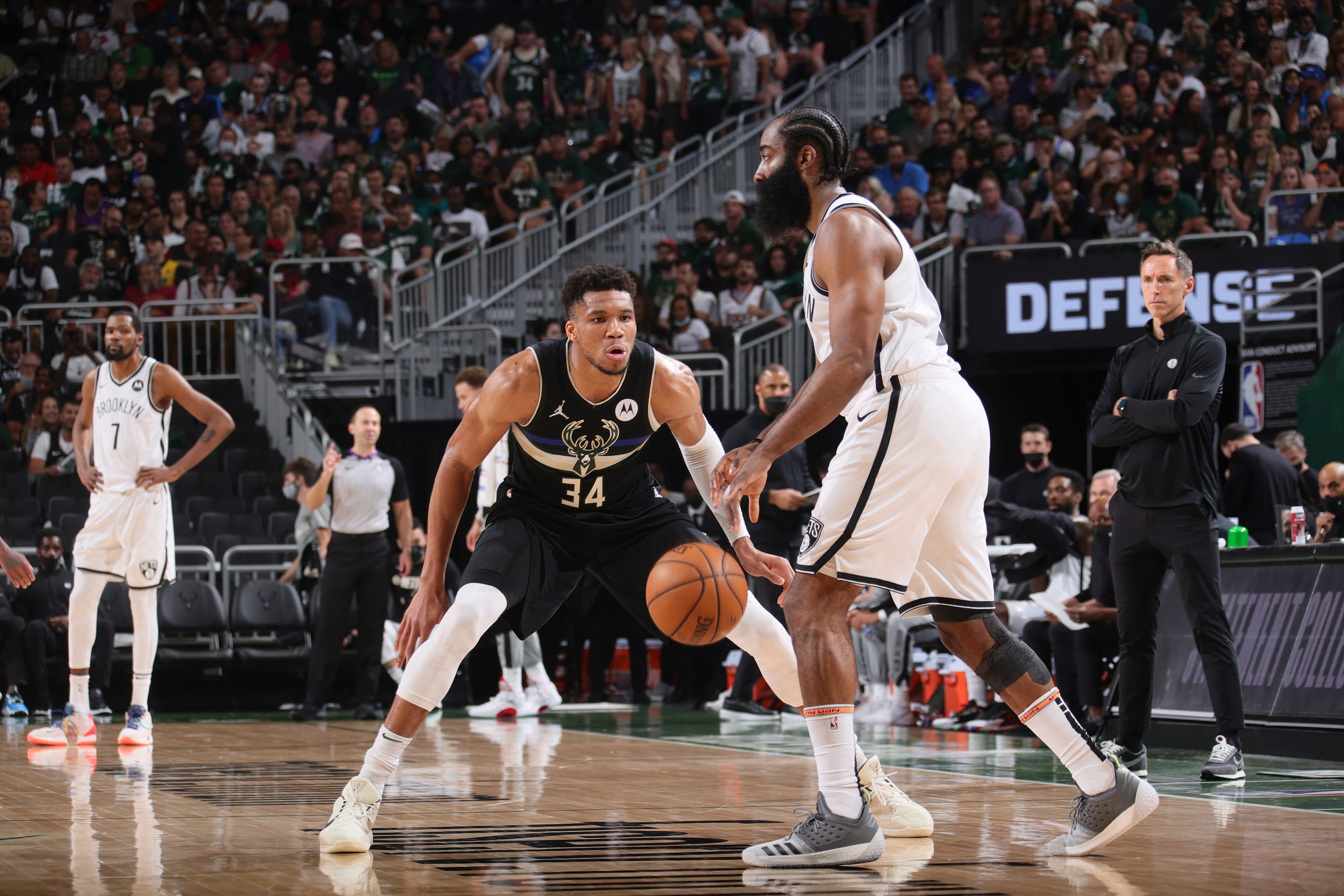 MILWAUKEE, WI - JUNE 17: Giannis Antetokounmpo #34 of the Milwaukee Bucks plays defense as James Harden #13 of the Brooklyn Nets handles the ball during the game during Round 2, Game 6 of the 2021 NBA Playoffs on June 17, 2021 at the Fiserv Forum Center in Milwaukee, Wisconsin. NOTE TO USER: User expressly acknowledges and agrees that, by downloading and or using this Photograph, user is consenting to the terms and conditions of the Getty Images License Agreement. Mandatory Copyright Notice: Copyright 2021 NBAE (Photo by Nathaniel S. Butler/NBAE via Getty Images).
