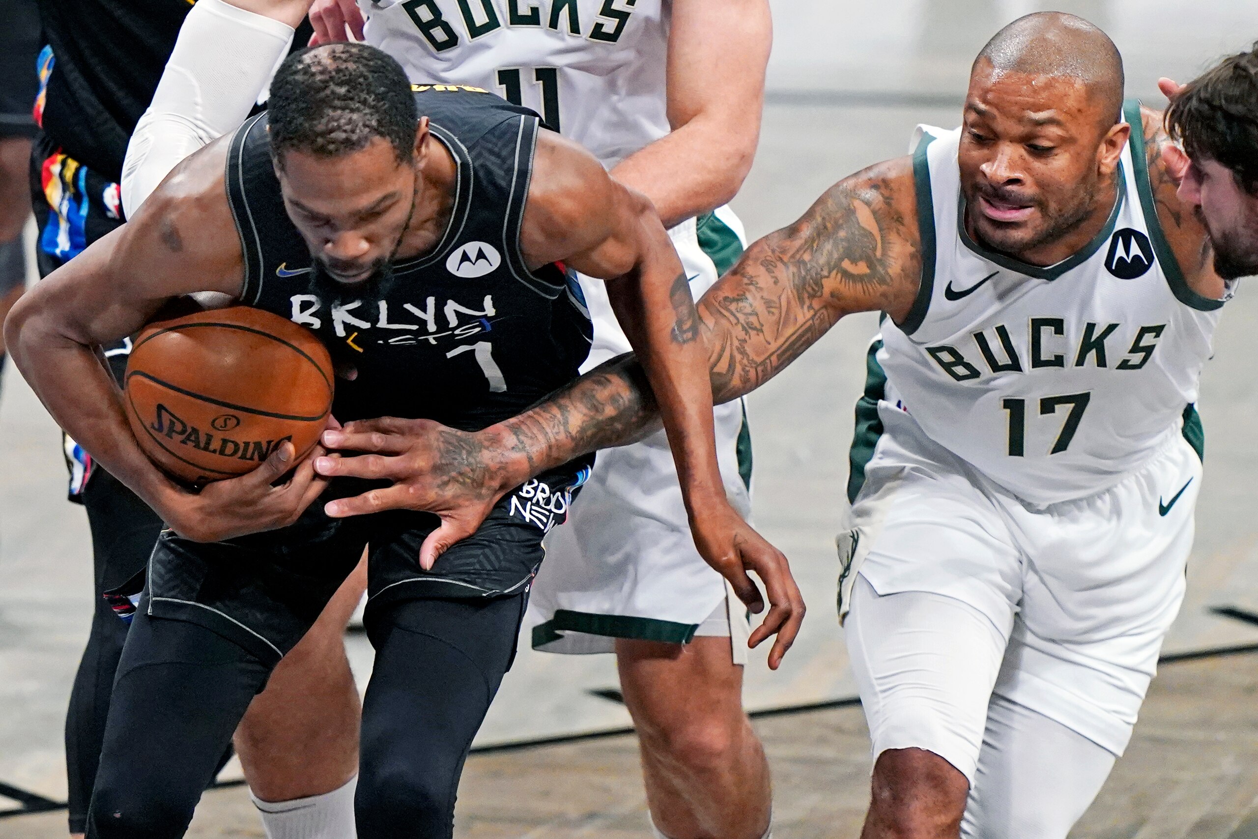 Milwaukee Bucks forward P.J. Tucker (17) tries to force a turnover as Brooklyn Nets forward Kevin Durant (7) secures the ball in Game 5 of a second-round NBA basketball playoff series, Tuesday, June 15, 2021, in New York. (AP Photo/Kathy Willens) Milwaukee Bucks forward P.J. Tucker (17) tries to force a turnover as Brooklyn Nets forward Kevin Durant (7) secures the ball in Game 5 of a second-round NBA basketball playoff series, Tuesday, June 15, 2021, in New York. (AP Photo/Kathy Willens)