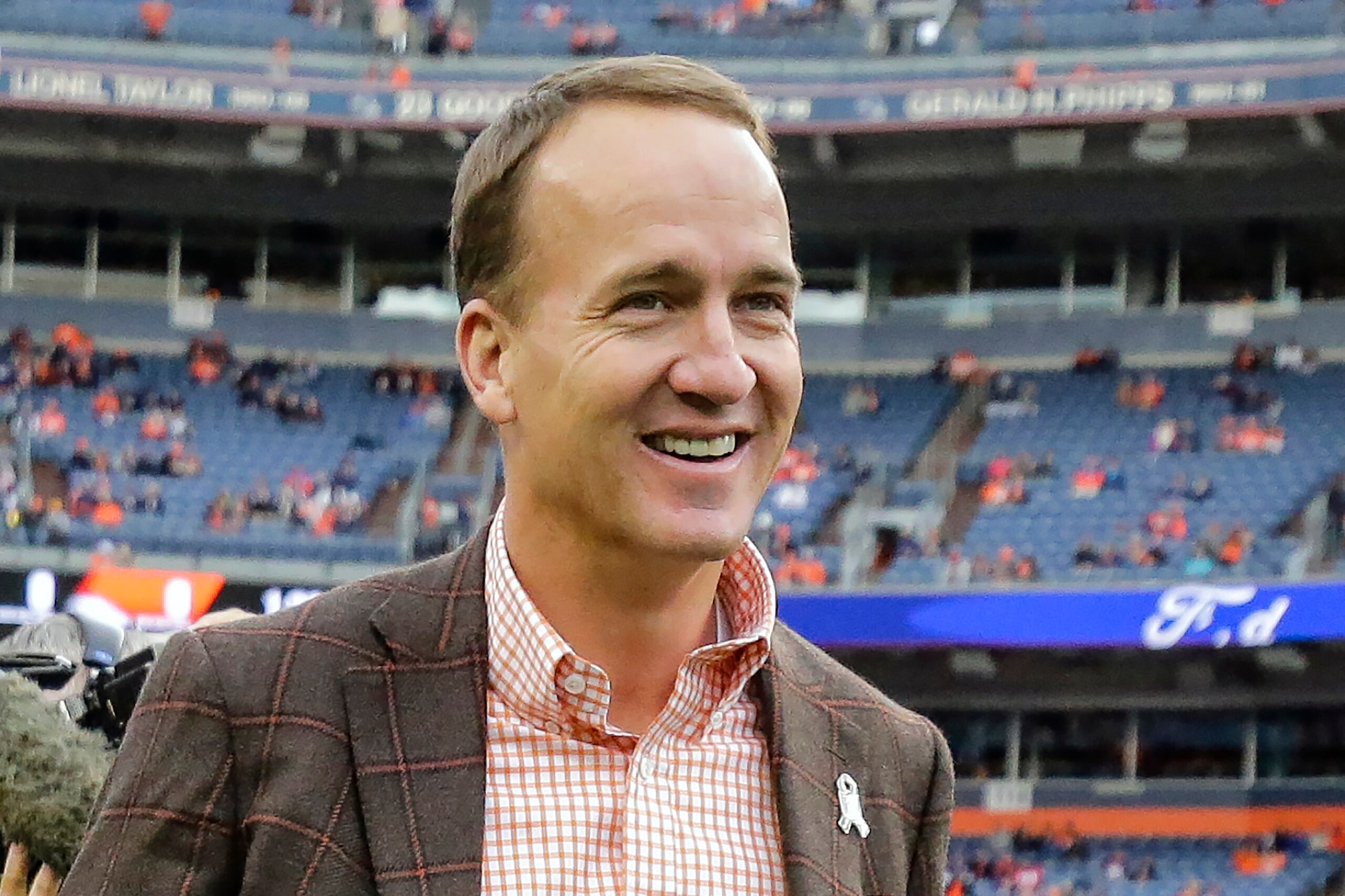 FILE - Former Denver Broncos quarterback Peyton manning talks prior to an NFL football game between the Denver Broncos and the Houston Texans, Sunday, Nov. 4, 2018, in Denver. Peyton Manning and Charles Woodson are among 14 first-year eligible candidates for the Pro Football Hall of Fame. Peyton Manning and Charles Woodson are among 14 first-year eligible candidates for the Pro Football Hall of Fame. (AP Photo/Jack Dempsey, File)