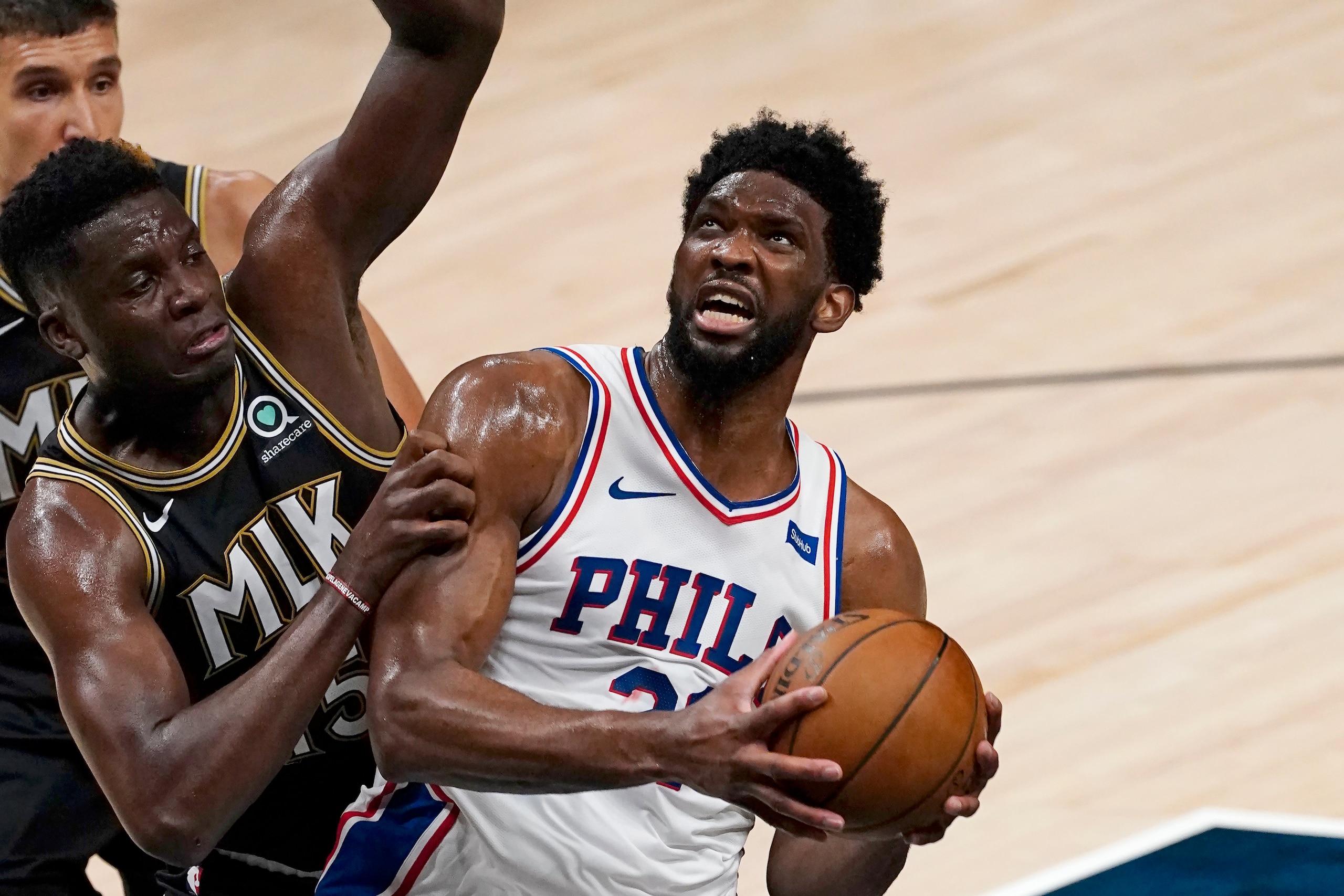 Philadelphia 76ers center Joel Embiid (21) is defended by Atlanta Hawks center Clint Capela (15) as he goes in for a basket during the first half of Game 6 of an NBA basketball Eastern Conference semifinal series Friday, June 18, 2021, in Atlanta. (AP Photo/John Bazemore) Philadelphia 76ers center Joel Embiid (21) is defended by Atlanta Hawks center Clint Capela (15) as he goes in for a basket during the first half of Game 6 of an NBA basketball Eastern Conference semifinal series Friday, June 18, 2021, in Atlanta. (AP Photo/John Bazemore)