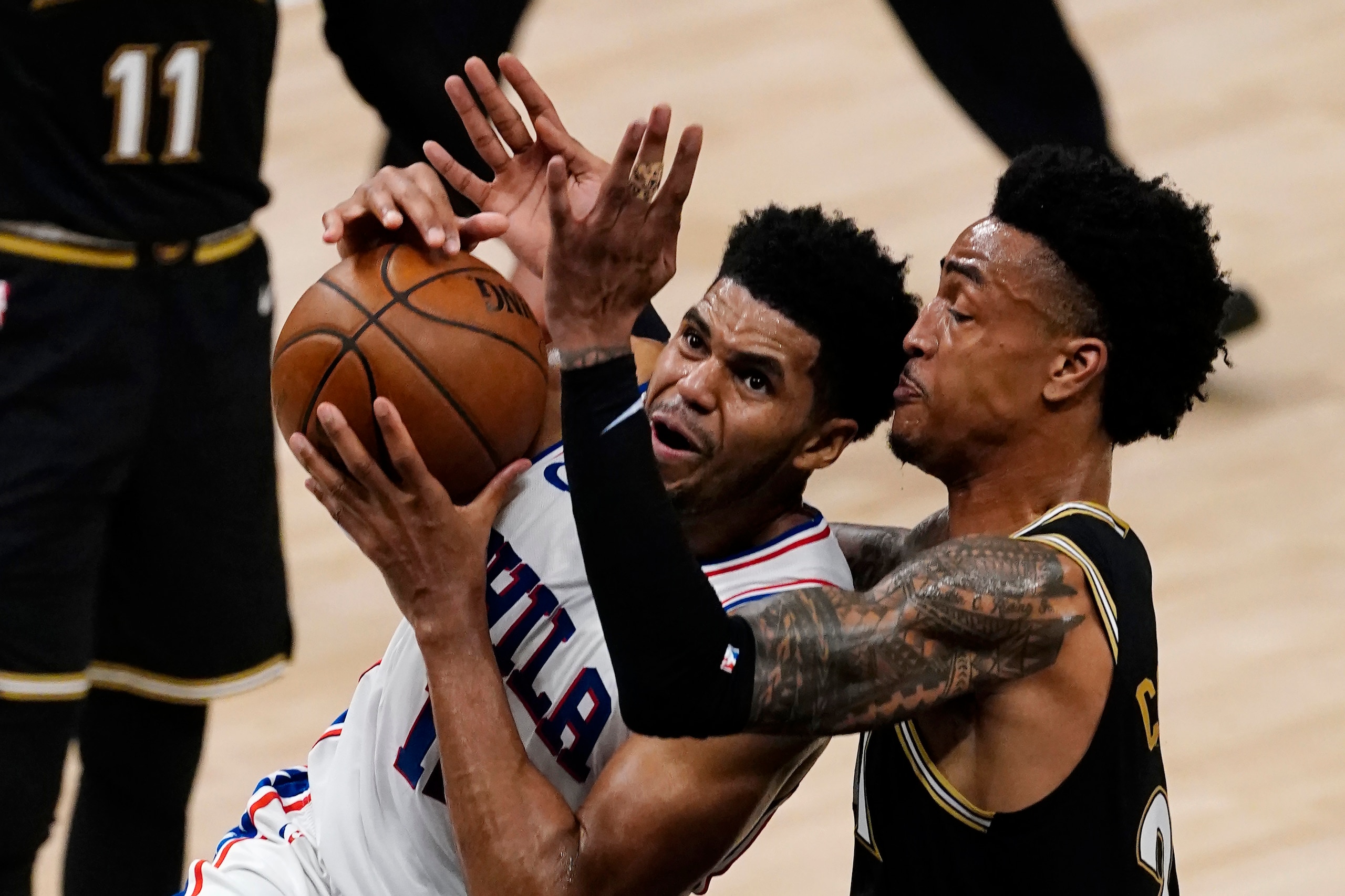 CORRECTS TO 76ERS' TOBIAS HARRIS NOT GARY CLARK - Philadelphia 76ers' Tobias Harris, left, drives against Atlanta Hawks forward John Collins (20) during the first half of Game 6 of an NBA basketball playoff Eastern Conference semifinal, Friday, June 18, 2021, in Atlanta. (AP Photo/John Bazemore) CORRECTS TO 76ERS' TOBIAS HARRIS NOT GARY CLARK - Philadelphia 76ers' Tobias Harris, left, drives against Atlanta Hawks forward John Collins (20) during the first half of Game 6 of an NBA basketball playoff Eastern Conference semifinal, Friday, June 18, 2021, in Atlanta. (AP Photo/John Bazemore)