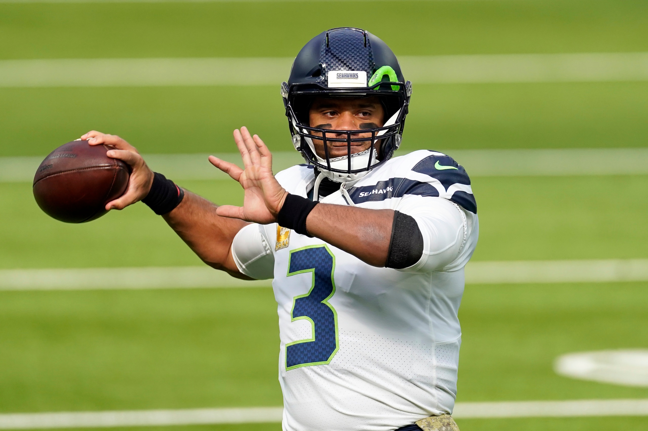 FILE - In this Sunday, Nov. 15, 2020 file photo, Seattle Seahawks quarterback Russell Wilson (3) warms up before an NFL football game against the Los Angeles Rams in Inglewood, Calif. Seattle Seahawks coach Pete Carroll and general manager John Schneider spend Wednesday, April 28, 2021 talking about their relationship with their starting quarterback, the result of months of silence on the subject and the fact they have just three picks in the NFL draft. (AP Photo/Ashley Landis, File)
