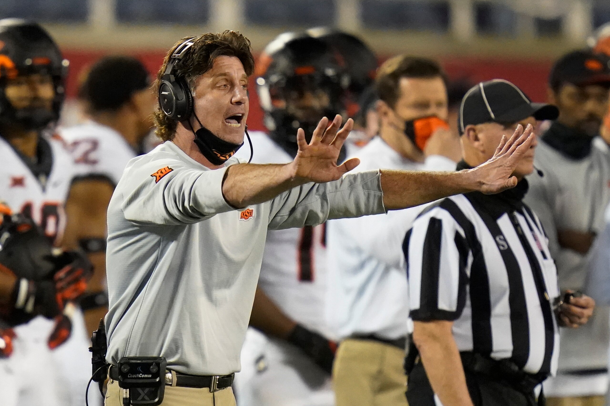 Oklahoma State head coach Mike Gundy shouts instructions to his players during the second half of the Cheez-it Bowl NCAA college football game against Miami, Tuesday, Dec. 29, 2020, in Orlando, Fla. (AP Photo/John Raoux)