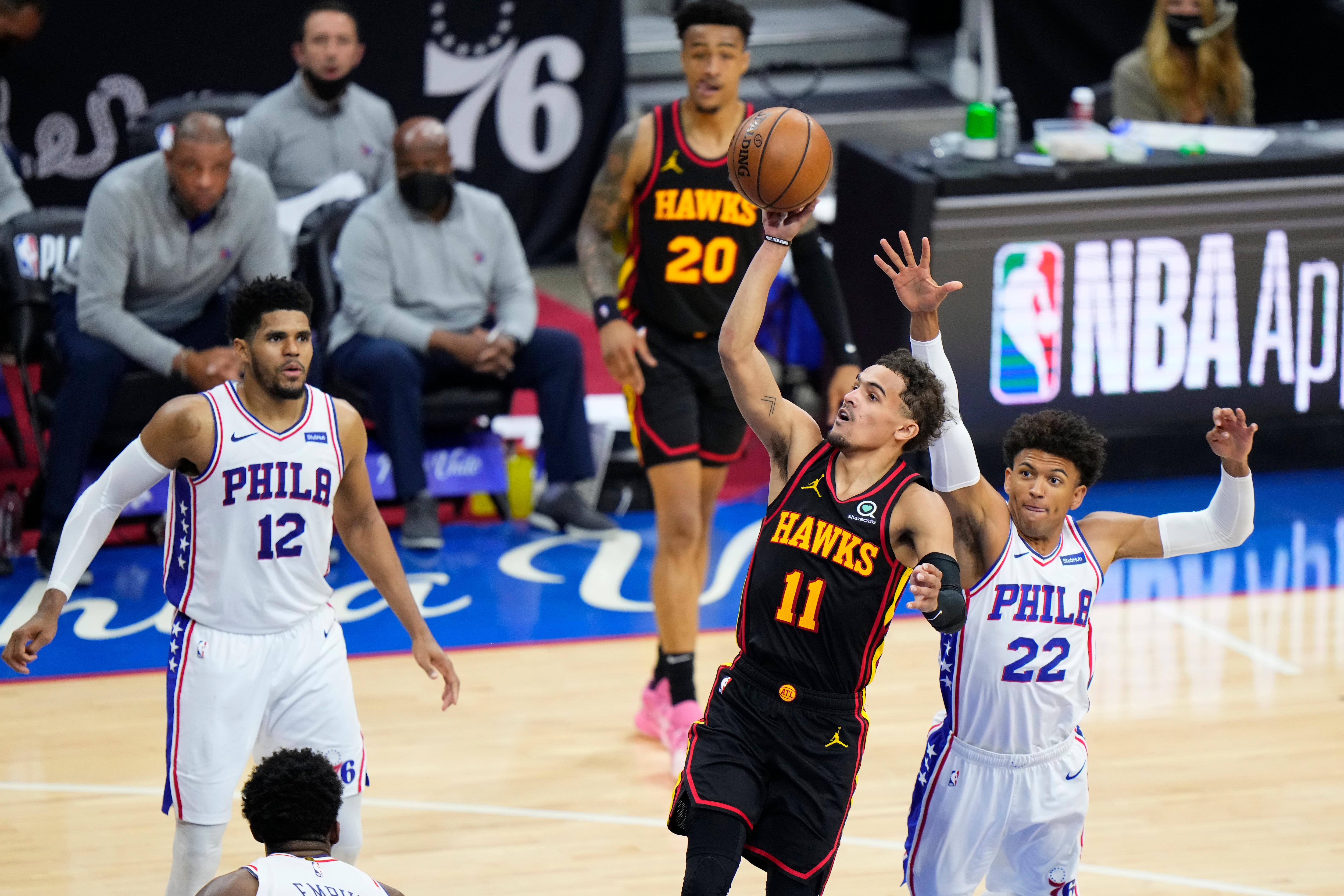 Atlanta Hawks' Trae Young (11) goes up for a shot against Philadelphia 76ers' Matisse Thybulle (22) during the second half of Game 7 in a second-round NBA basketball playoff series, Sunday, June 20, 2021, in Philadelphia. (AP Photo/Matt Slocum)
