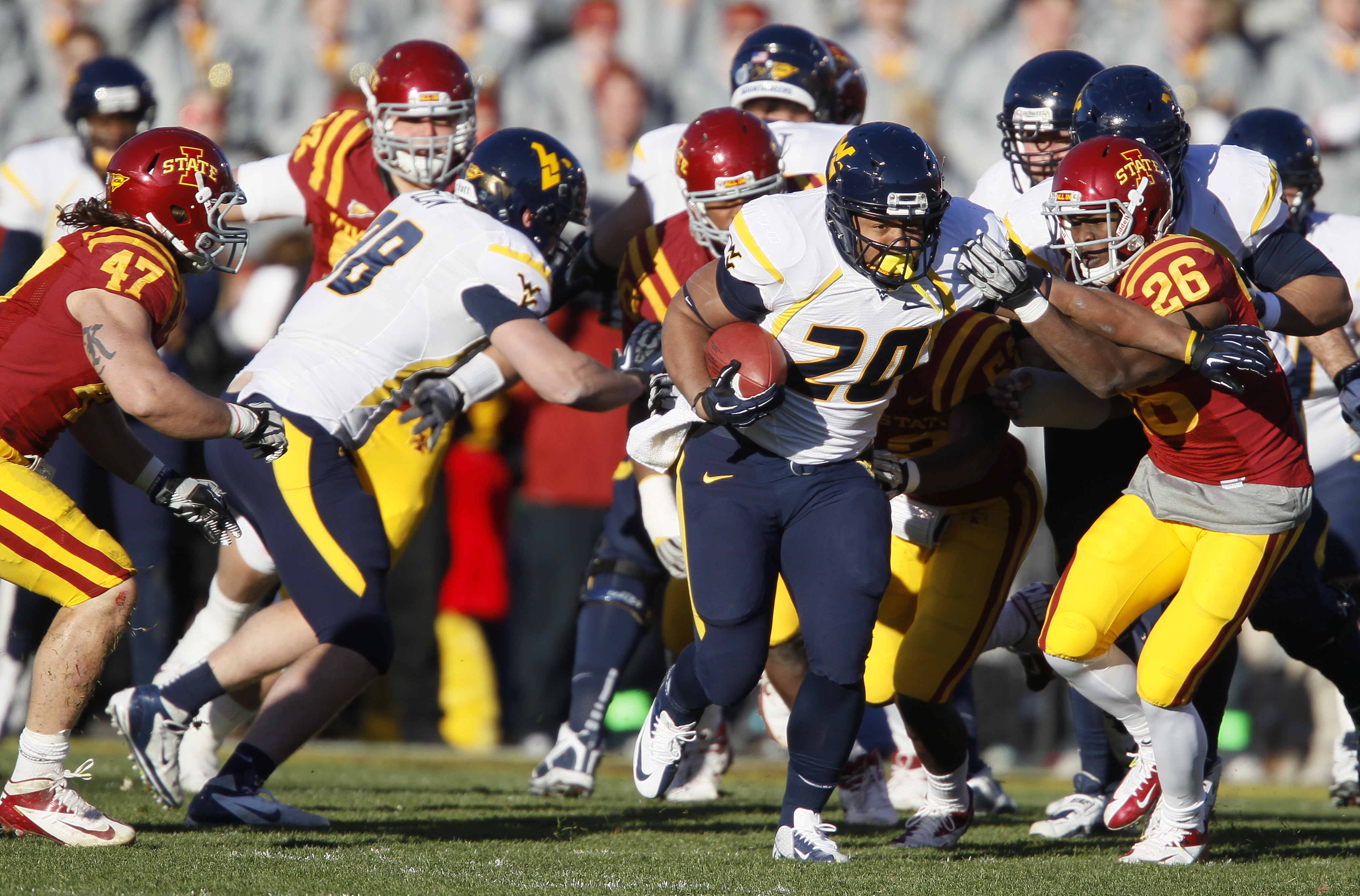 Iowa State defensive back Deon Broomfield (26) chases down West Virginia running back Shawne Alston (20) during the first half of an NCAA college football game on Friday, Nov. 23, 2012, in Ames, Iowa. (AP Photo/Matthew Putney)