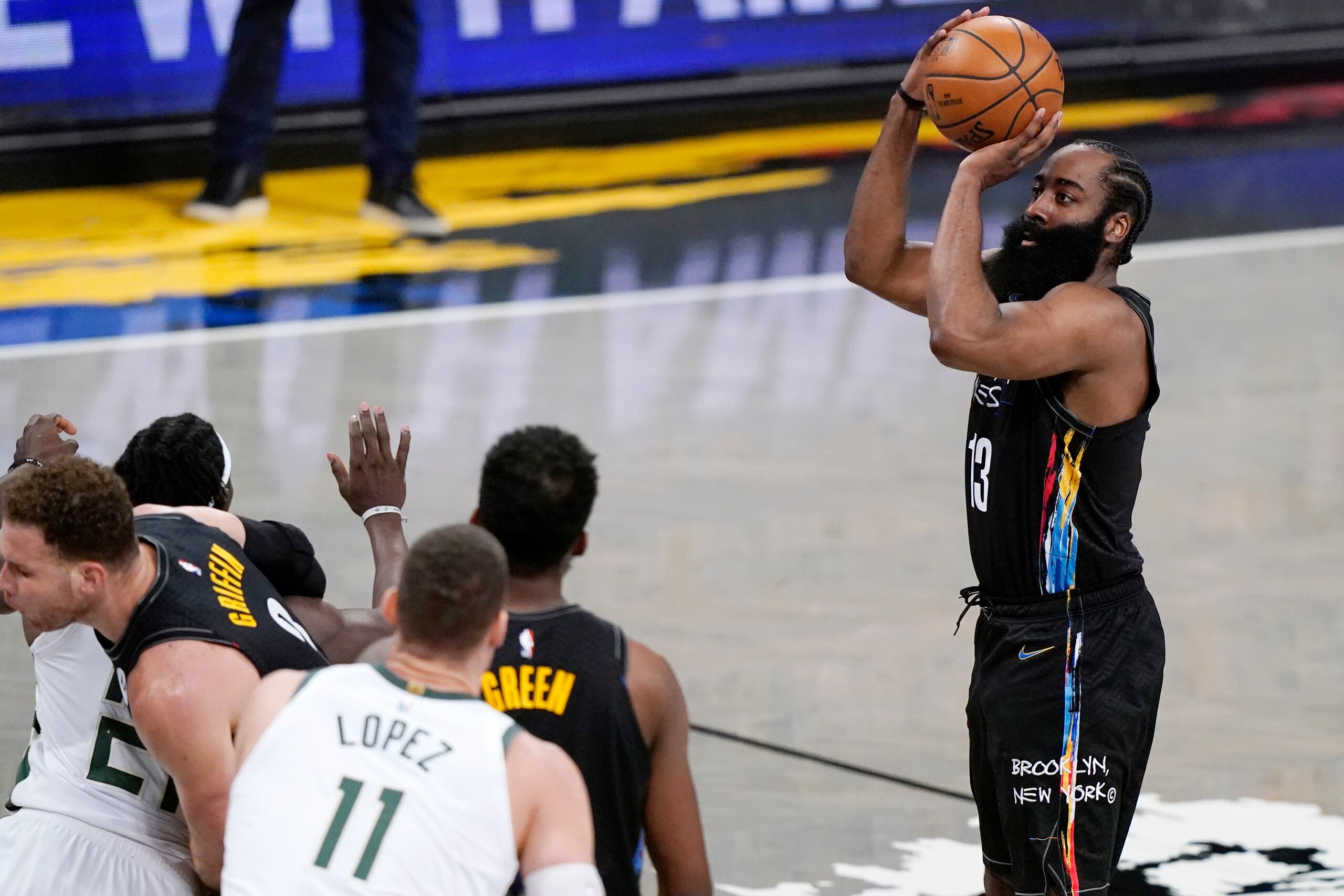 Brooklyn Nets guard James Harden (13) shoots as Brooklyn Nets forwards Jeff Green (8) and Blake Griffin (2) fend off Milwaukee Bucks players during the second half of Game 5 of a second-round NBA basketball playoff series, Tuesday, June 15, 2021, in New York. (AP Photo/Kathy Willens)