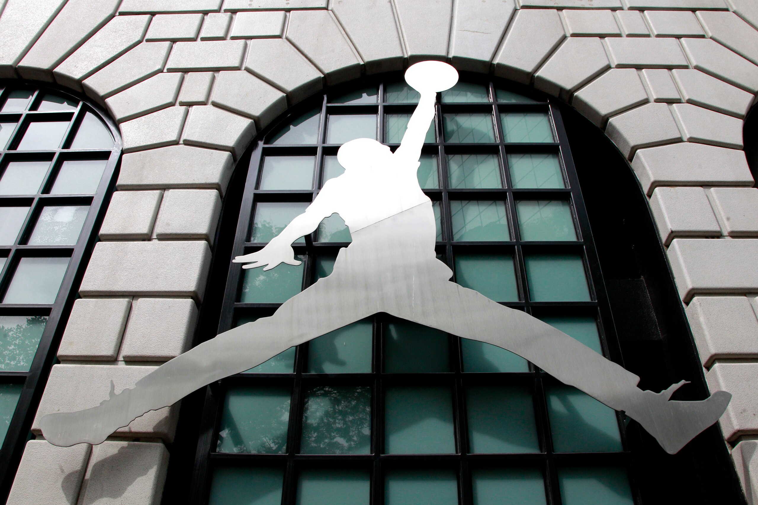 The Nike Air Jordan logo is shown in front of the Niketown store in downtown Portland, Ore., Monday, June 27, 2011. Nike Inc.'s fourth-quarter net profit rose 14 percent to beat expectations as the company's sales improved around the globe. (AP Photo/Rick Bowmer)