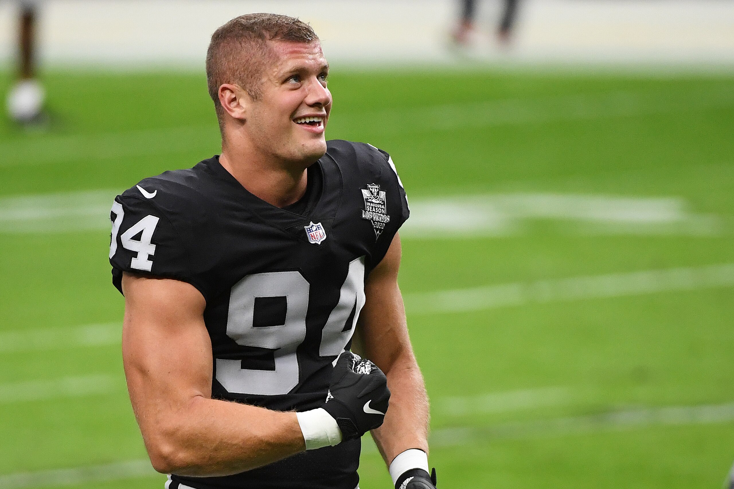 LAS VEGAS, NEVADA - NOVEMBER 15: Carl Nassib #94 of the Las Vegas Raiders flexes while smiling during warmups before a game against the Denver Broncos at Allegiant Stadium on November 15, 2020 in Las Vegas, Nevada. (Photo by Ethan Miller/Getty Images) LAS VEGAS, NEVADA - NOVEMBER 15: Carl Nassib #94 of the Las Vegas Raiders flexes while smiling during warmups before a game against the Denver Broncos at Allegiant Stadium on November 15, 2020 in Las Vegas, Nevada. (Photo by Ethan Miller/Getty Images)