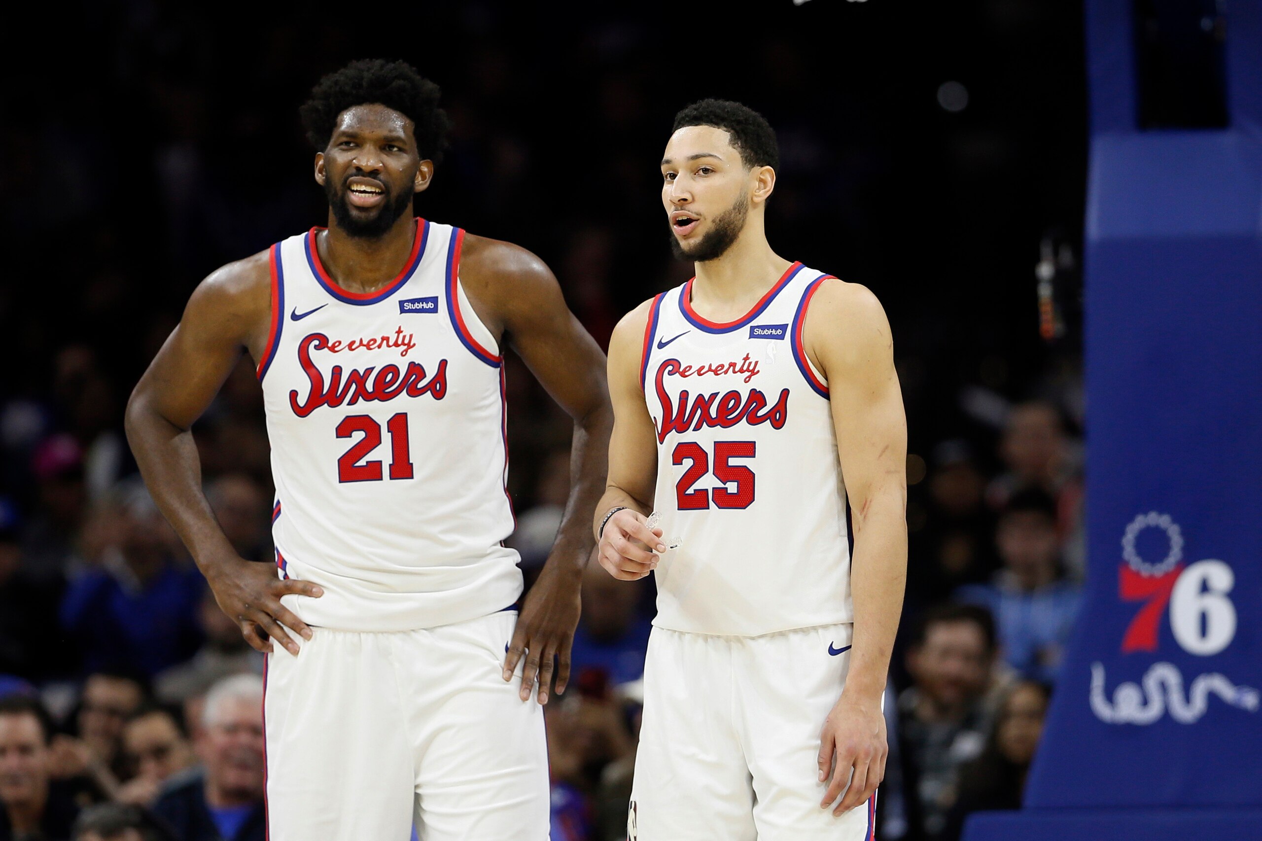 FILE - In this Dec. 13, 2019, file photo, Philadelphia 76ers' Ben Simmons, right, and Joel Embiid talk during an NBA basketball game against the New Orleans Pelicans in Philadelphia. Simmons says he’s 100% healthy following surgery on his left knee in August that kept him from playing in the postseason. Simmons is tight with center Joel Embiid and says the two franchise stars are ready to lead the Sixers to their first NBA championship since 1983.(AP Photo/Matt Slocum, File)