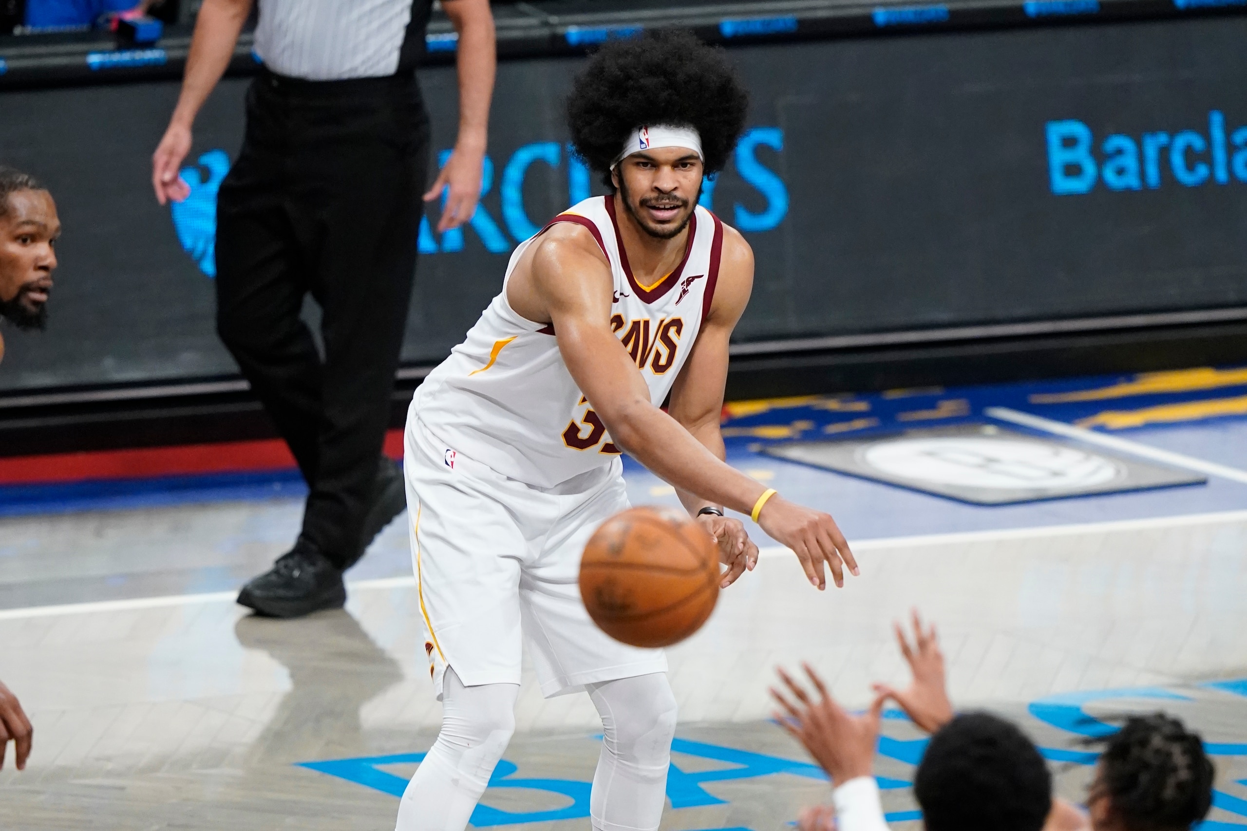 Cleveland Cavaliers' Jarrett Allen, center, passes to Isaac Okoro during the second half of an NBA basketball game against the Brooklyn Nets Sunday, May 16, 2021, in New York. (AP Photo/Frank Franklin II)