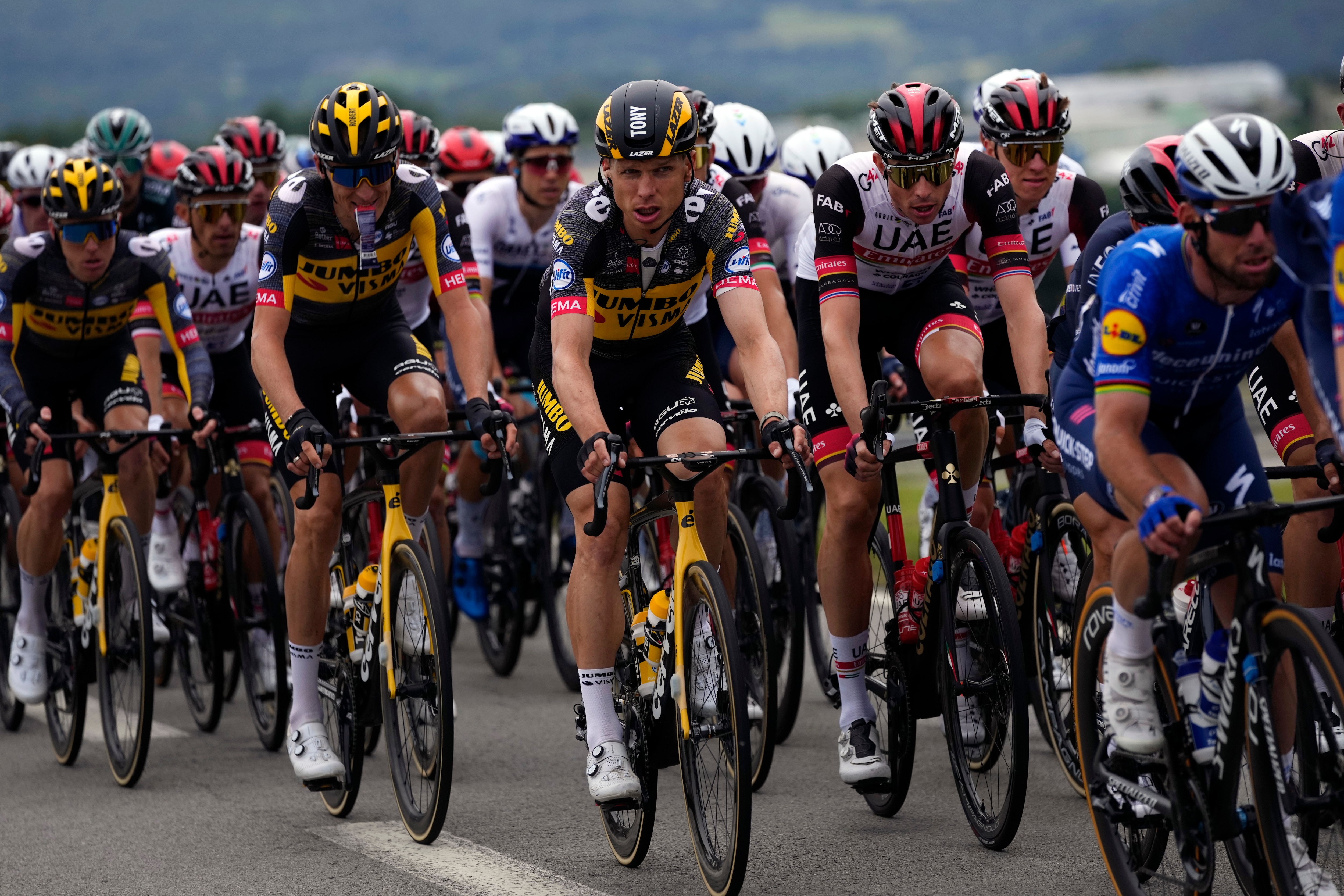 German Tony Martin, center, rides with the pack during the first stage of the Tour de France cycling race over 197.8 kilometers (122.9 miles) with start in Brest and finish in Landerneau, France, Saturday, June 26, 2021. (AP Photo/Daniel Cole)