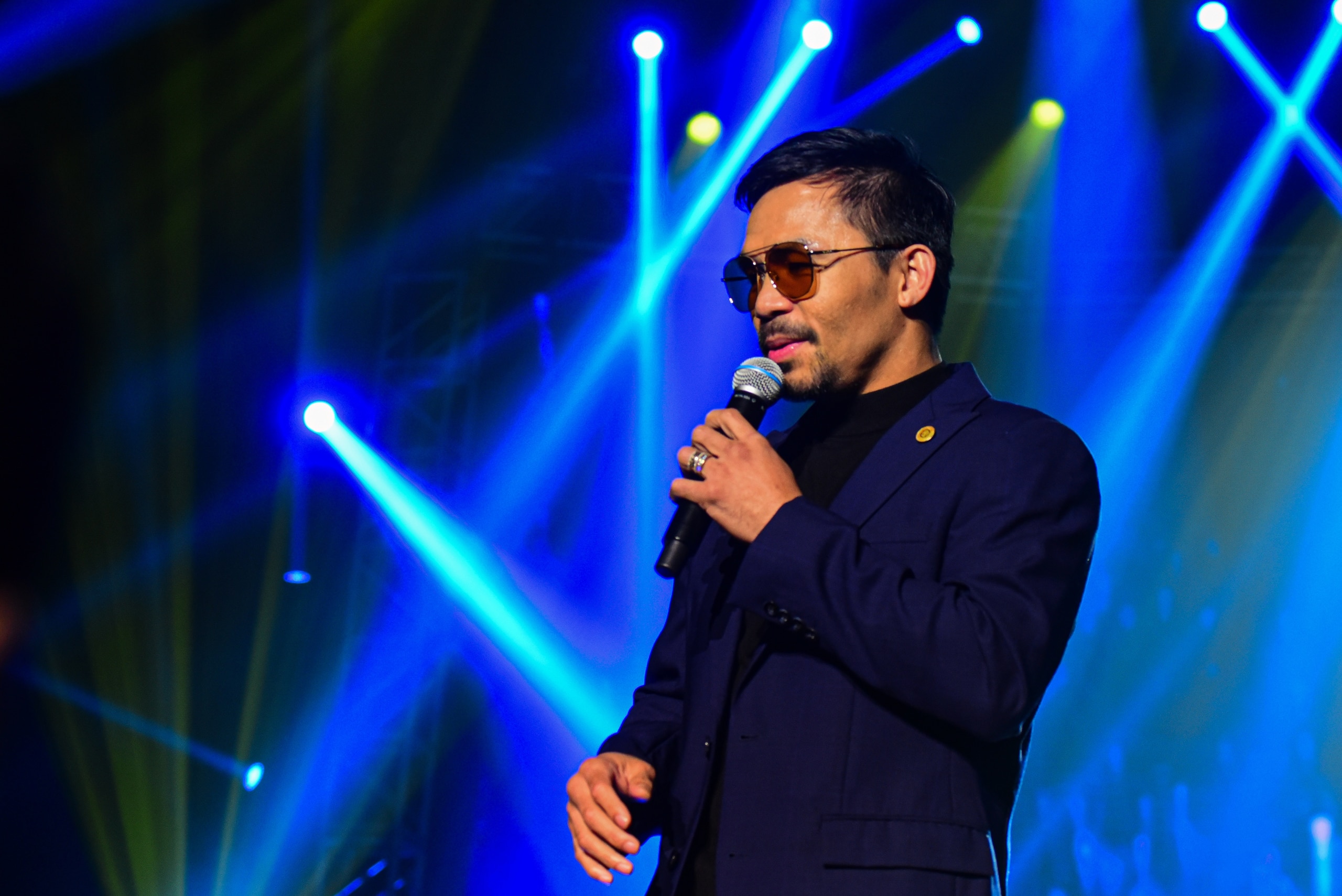 In this photo taken September 1, 2019, Filipino boxing icon Manny Pacquiao performs during a free concert to coincide with the launching of his own cryptocurrency "Pac Token" at a sports centre in Manila. (Photo by MARIA TAN / AFP)        (Photo credit should read MARIA TAN/AFP via Getty Images)