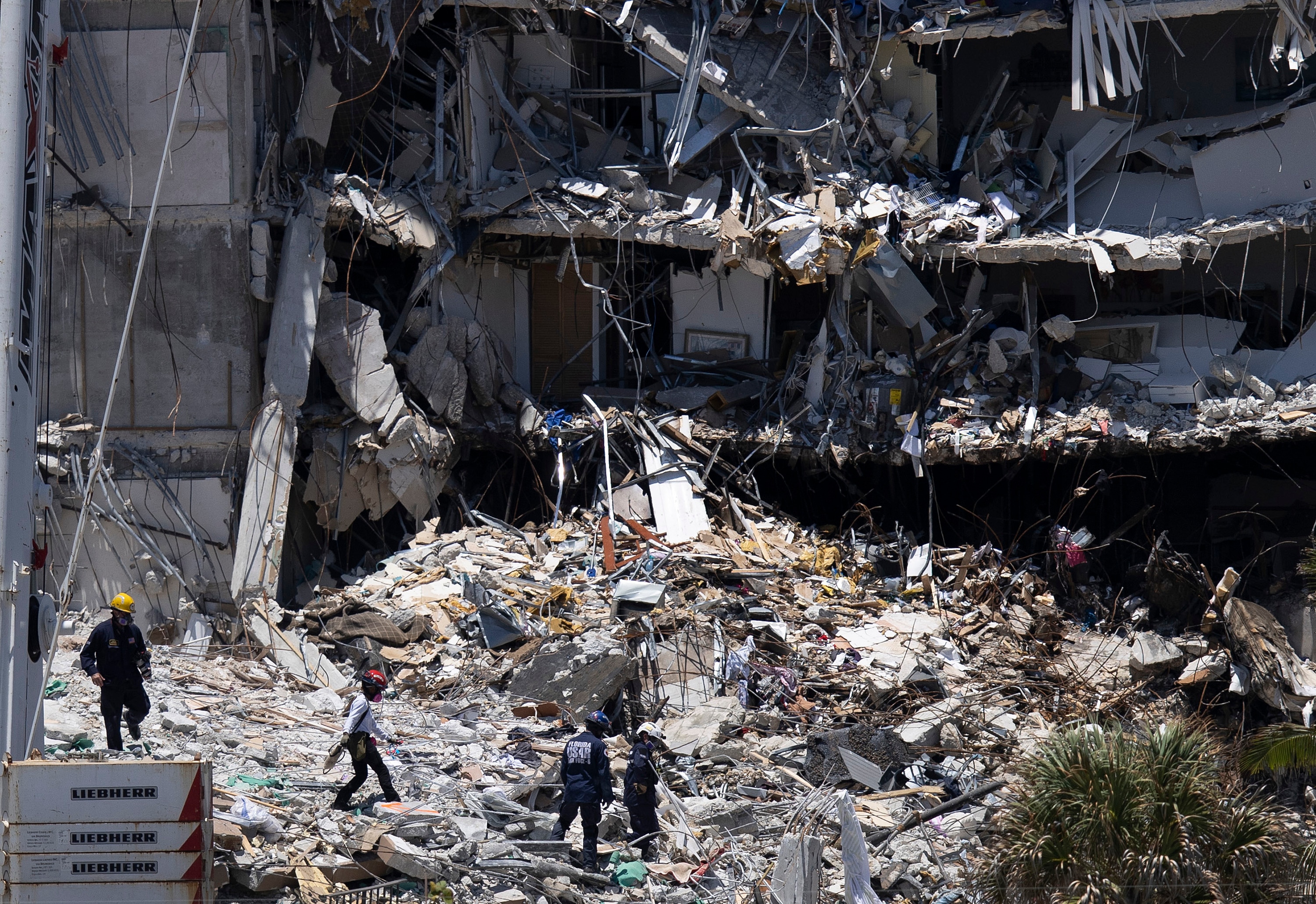 SURFSIDE, FLORIDA - JUNE 27: Search and Rescue teams look for possible survivors in the partially collapsed 12-story Champlain Towers South condo building on June 27, 2021 in Surfside, Florida. Over one hundred people are being reported as missing as the search-and-rescue effort continues. (Photo by Joe Raedle/Getty Images)