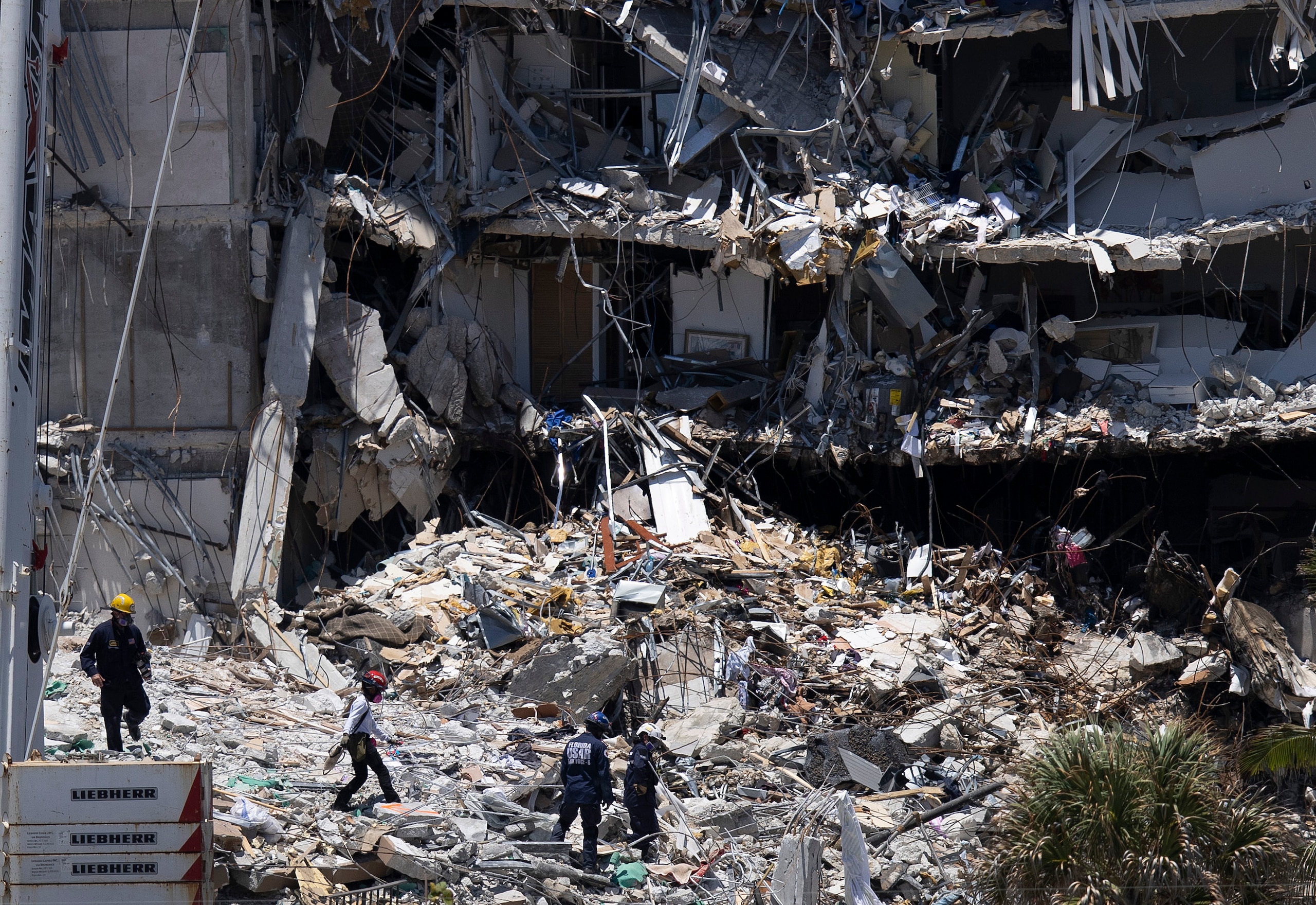 SURFSIDE, FLORIDA - JUNE 27: Search and Rescue teams look for possible survivors in the partially collapsed 12-story Champlain Towers South condo building on June 27, 2021 in Surfside, Florida. Over one hundred people are being reported as missing as the search-and-rescue effort continues. (Photo by Joe Raedle/Getty Images) SURFSIDE, FLORIDA - JUNE 27: Search and Rescue teams look for possible survivors in the partially collapsed 12-story Champlain Towers South condo building on June 27, 2021 in Surfside, Florida. Over one hundred people are being reported as missing as the search-and-rescue effort continues. (Photo by Joe Raedle/Getty Images)