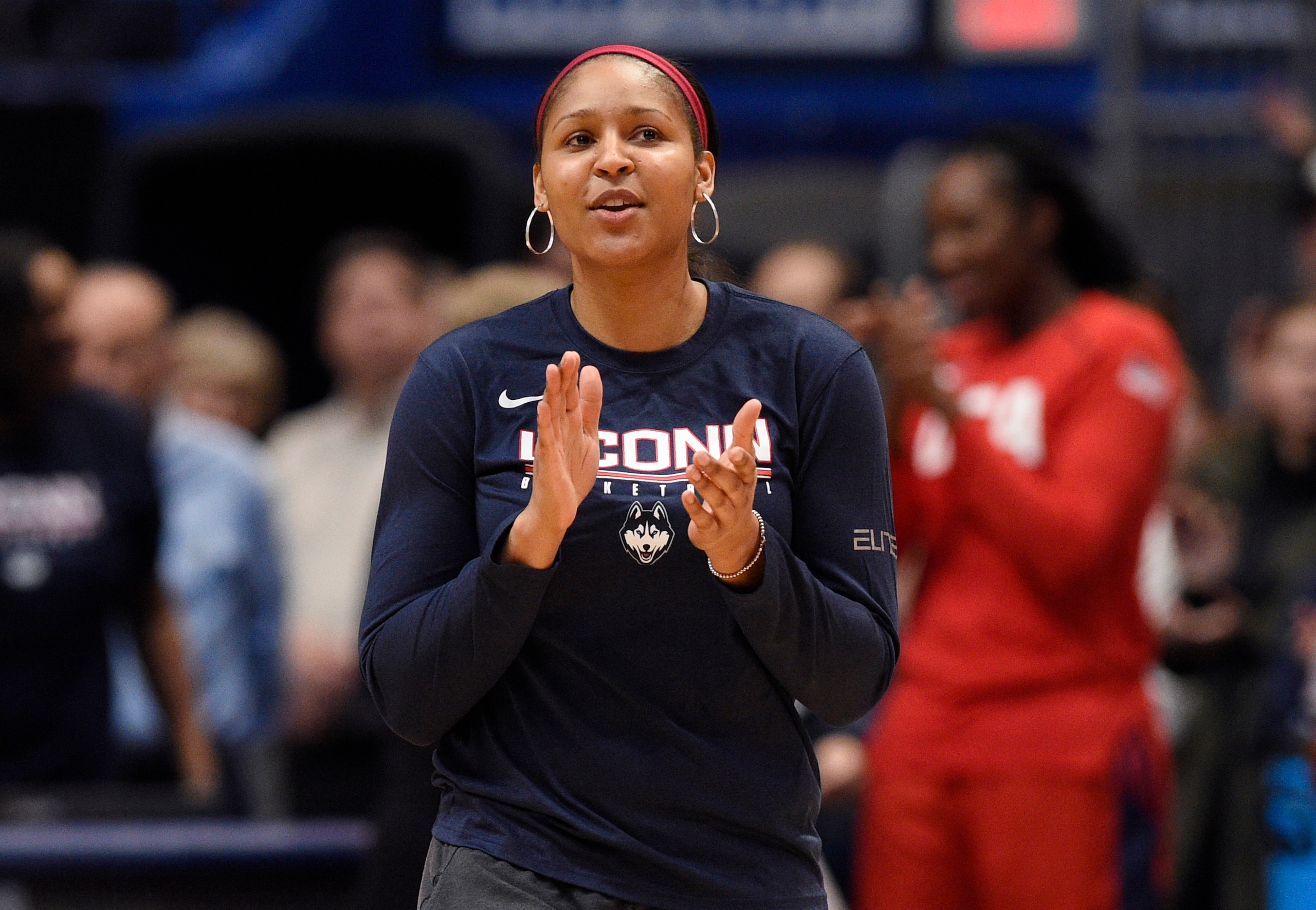 FILE - In this Jan. 27, 2020, file photo, former Connecticut and Minnesota Lynx player Maya Moore applauds in Hartford, Conn. Moore says she is not ready to return to the WNBA. The basketball star said on ABC’s Good Morning America that she remains focused for now on her marriage to Jonathan Irons and their activism for criminal justice reform. She has not played for the Minnesota Lynx since the 2018 season.  (AP Photo/Jessica Hill, File)