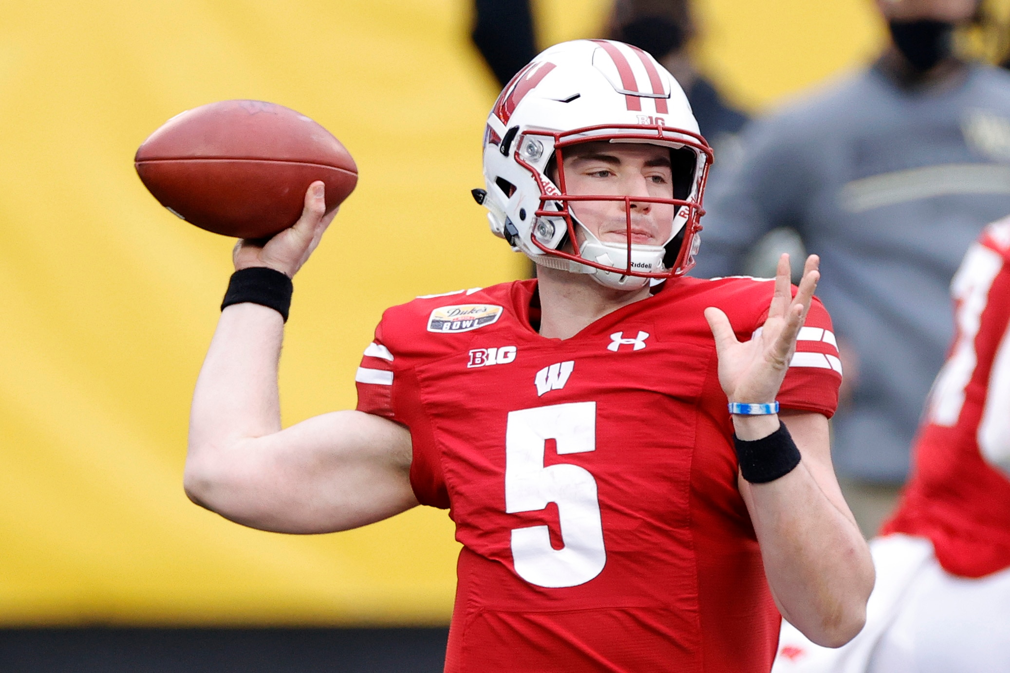 CHARLOTTE, NORTH CAROLINA - DECEMBER 30: Quarterback Graham Mertz #5 of the Wisconsin Badgers looks to pass against the Wake Forest Demon Deacons during the first quarter of the Duke's Mayo Bowl at Bank of America Stadium on December 30, 2020 in Charlotte, North Carolina. (Photo by Jared C. Tilton/Getty Images)