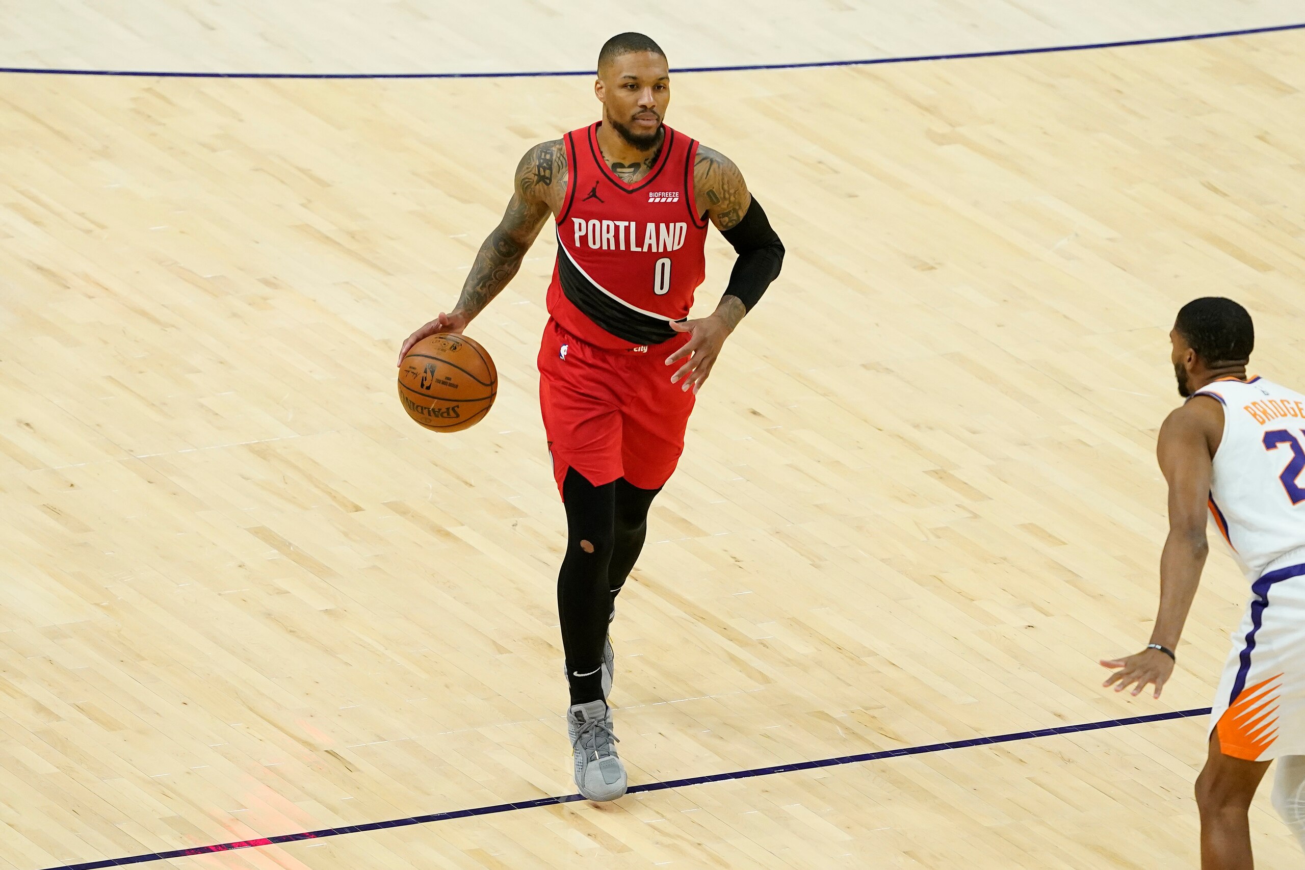 Portland Trail Blazers guard Damian Lillard (0) against the Phoenix Suns during the second half of an NBA basketball game, Thursday, May 13, 2021, in Phoenix. (AP Photo/Matt York) Portland Trail Blazers guard Damian Lillard (0) against the Phoenix Suns during the second half of an NBA basketball game, Thursday, May 13, 2021, in Phoenix. (AP Photo/Matt York)