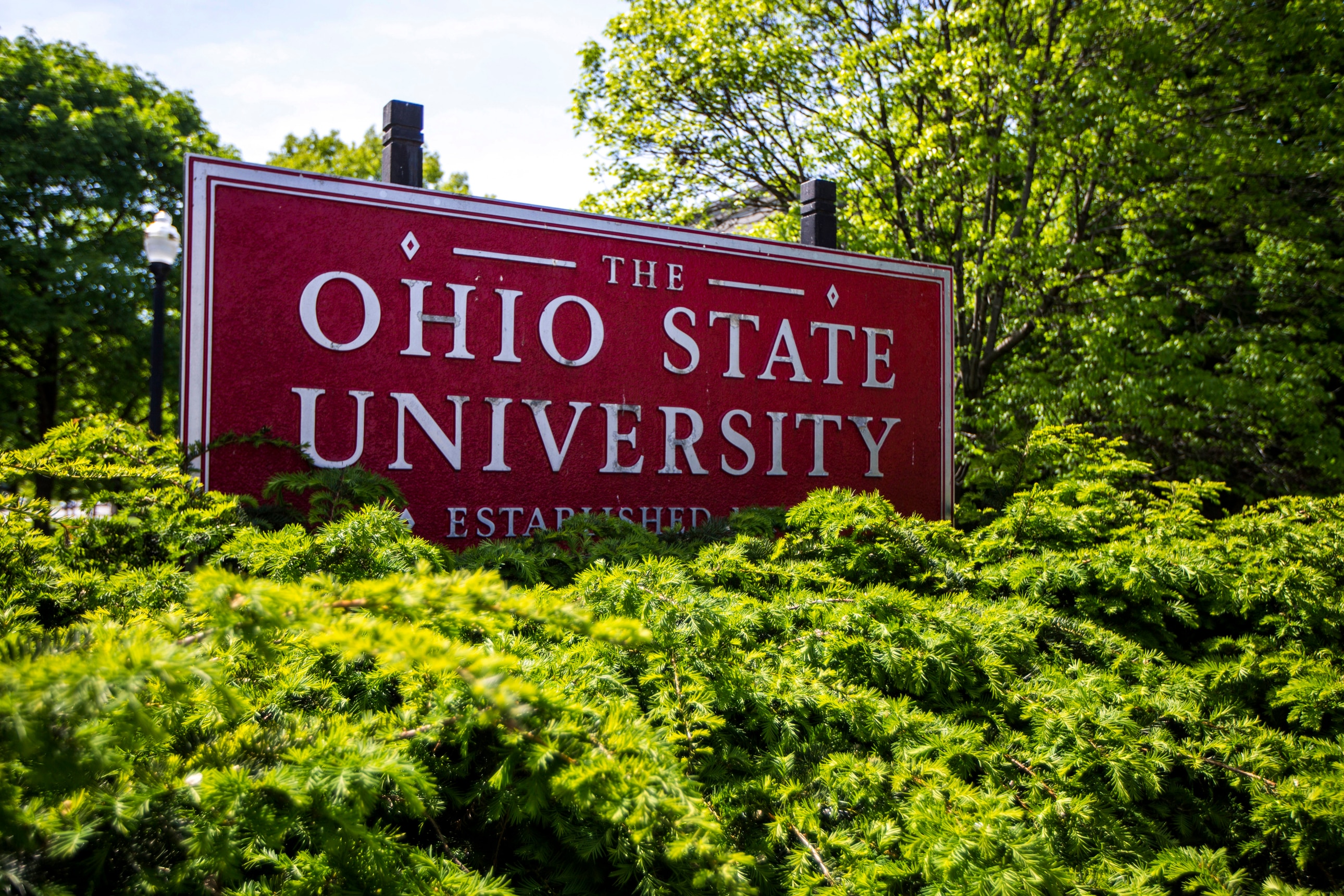 This May 8, 2019 photo shows a sign for Ohio State University in Columbus, Ohio. On Friday, May 17, 2019, the school said at least 177 men were sexually abused by Ohio State team doctor Richard Strauss who died years ago, according to findings from a law firm that investigated the accusations, concluding that school leaders knew at the time. (AP Photo/Angie Wang)