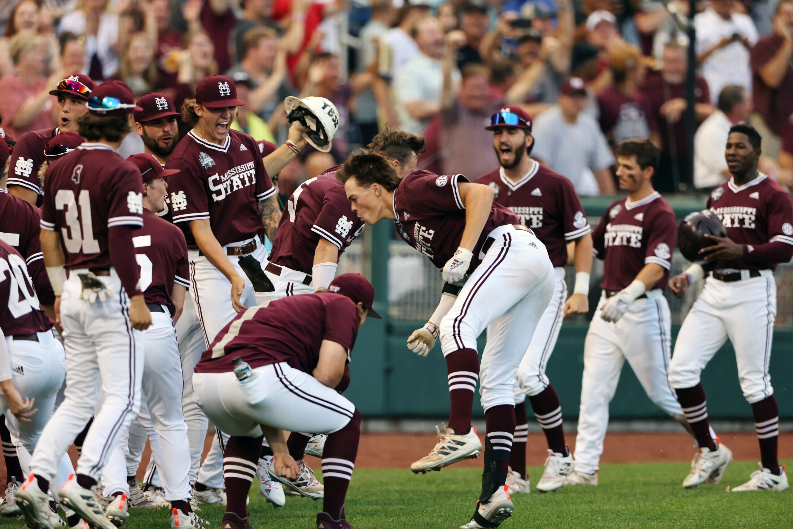 Mississippi State infielder Kellum Clark (11), center, celebrates a three-run home run against Vanderbilt during the seventh inning in Game 3 of the NCAA College World Series baseball finals, Wednesday, June 30, 2021, in Omaha, Neb. (AP Photo/Rebecca S. Gratz)