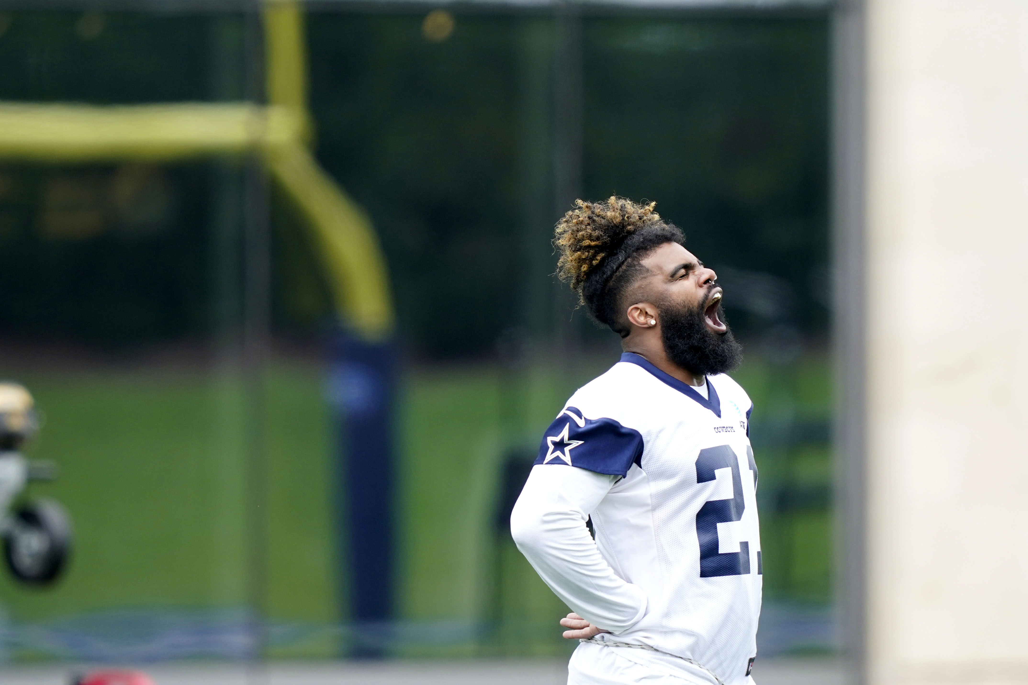 Dallas Cowboys running back Ezekiel Elliott (21) warms up during an NFL football team practice Wednesday, June 9, 2021, in Frisco, Texas. (AP Photo/LM Otero)