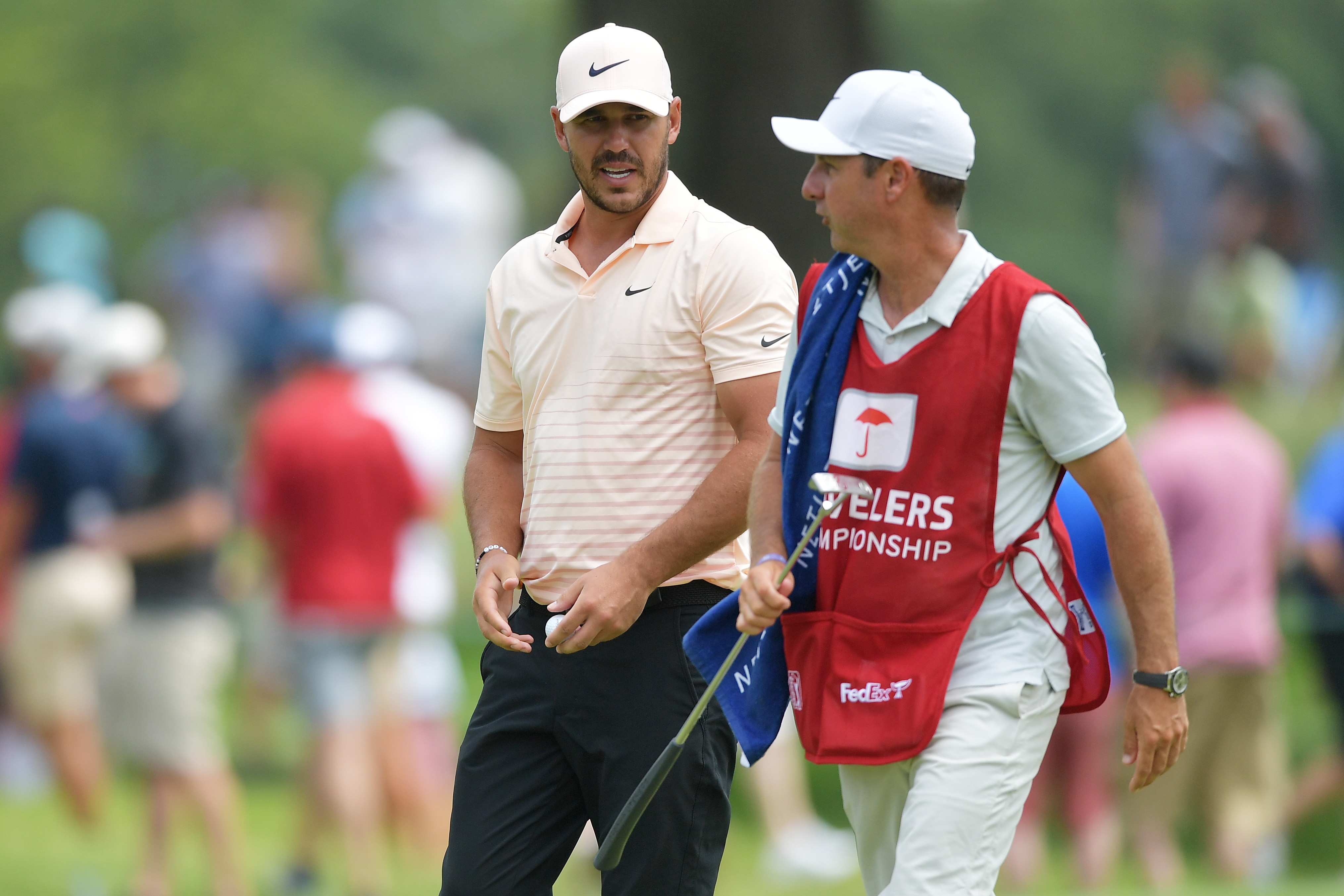 CROMWELL, CONNECTICUT - JUNE 27: Brooks Koepka of the United States talks with his caddie Ricky Elliott on the fourth green during the final round of the Travelers Championship at TPC River Highlands on June 27, 2021 in Cromwell, Connecticut. (Photo by Drew Hallowell/Getty Images)