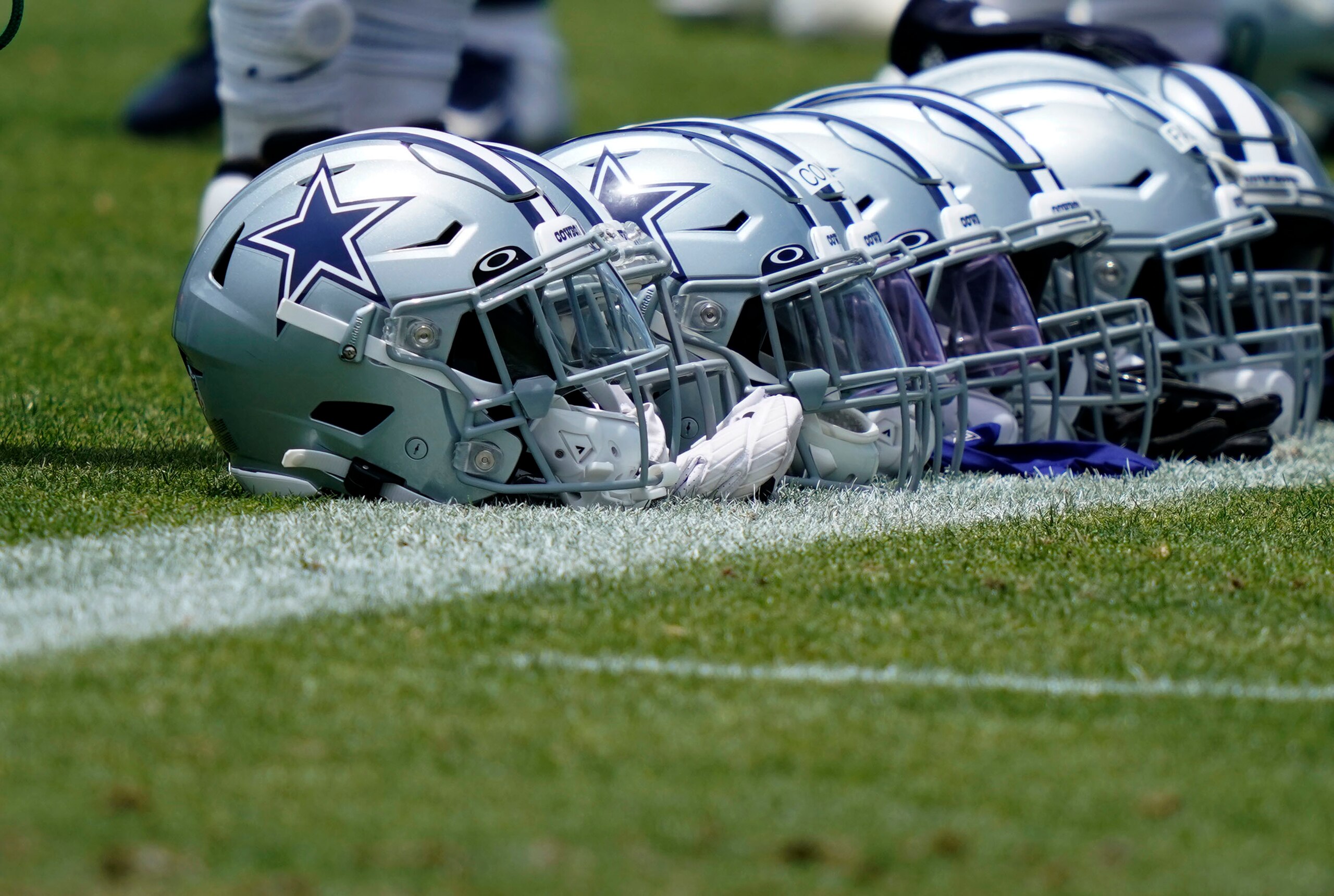 Dallas Cowboys helmets lines up during an NFL football team practice Tuesday, June 8, 2021, in Frisco, Texas. (AP Photo/LM Otero)