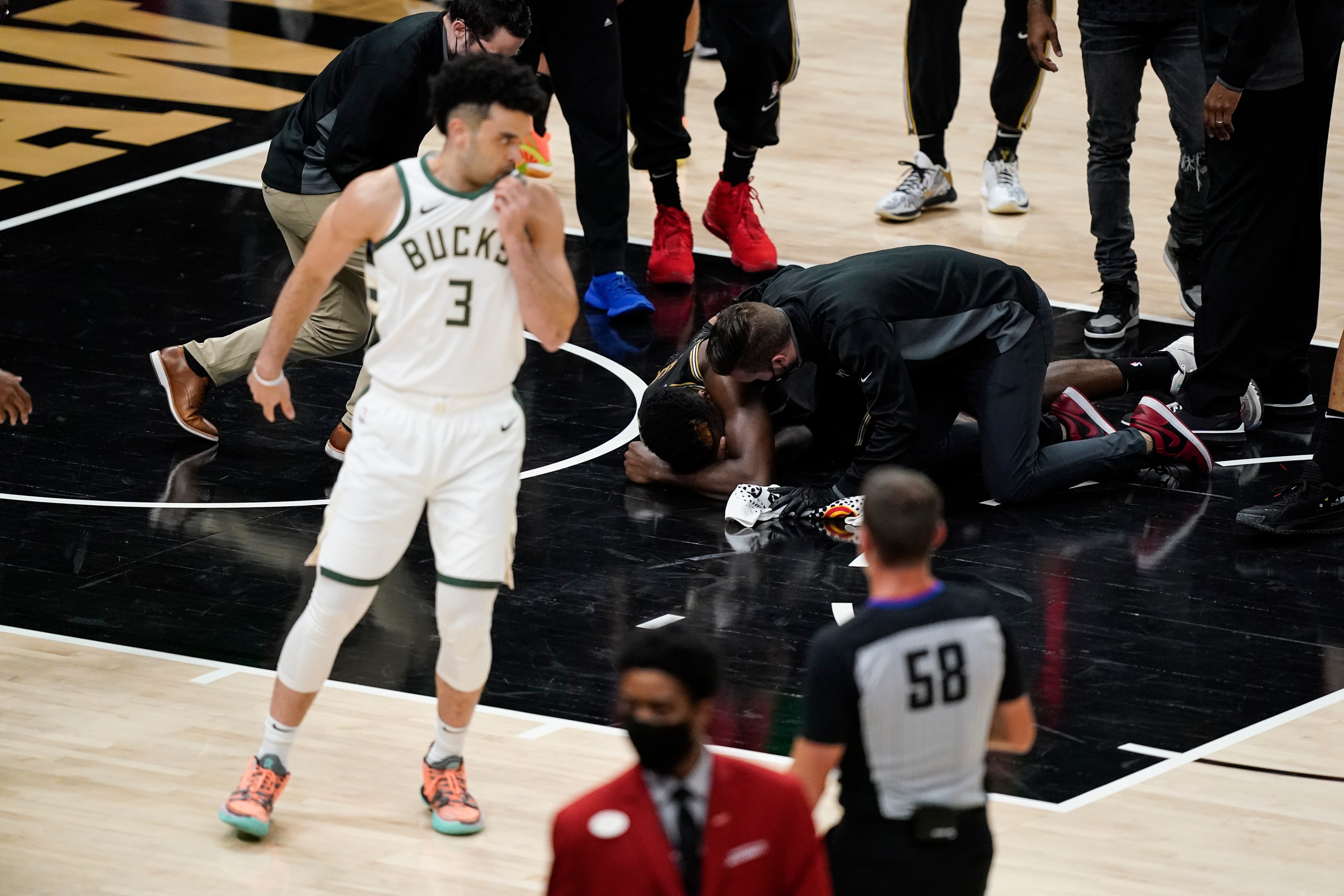 Atlanta Hawks' Clint Capela (15) falls to the ground after being hit during the second half of Game 4 of the NBA Eastern Conference basketball finals against the Milwaukee Bucks Tuesday, June 29, 2021, in Atlanta. (AP Photo/Brynn Anderson)