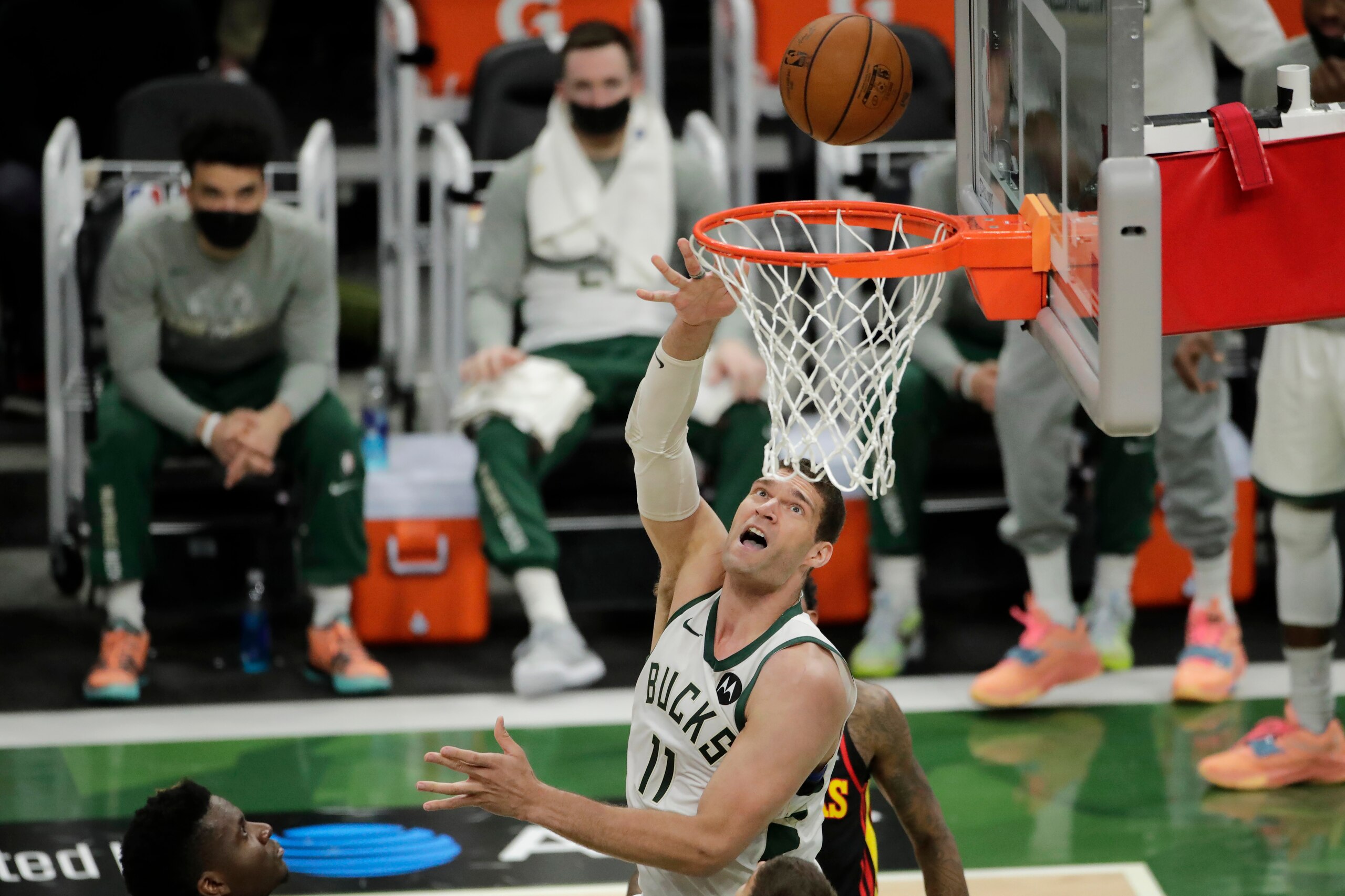 Milwaukee Bucks' Brook Lopez (11) shoots between multiple Atlanta Hawks defenders during the first half of Game 5 of the NBA Eastern Conference Finals Thursday, July 1, 2021, in Milwaukee. (AP Photo/Aaron Gash)