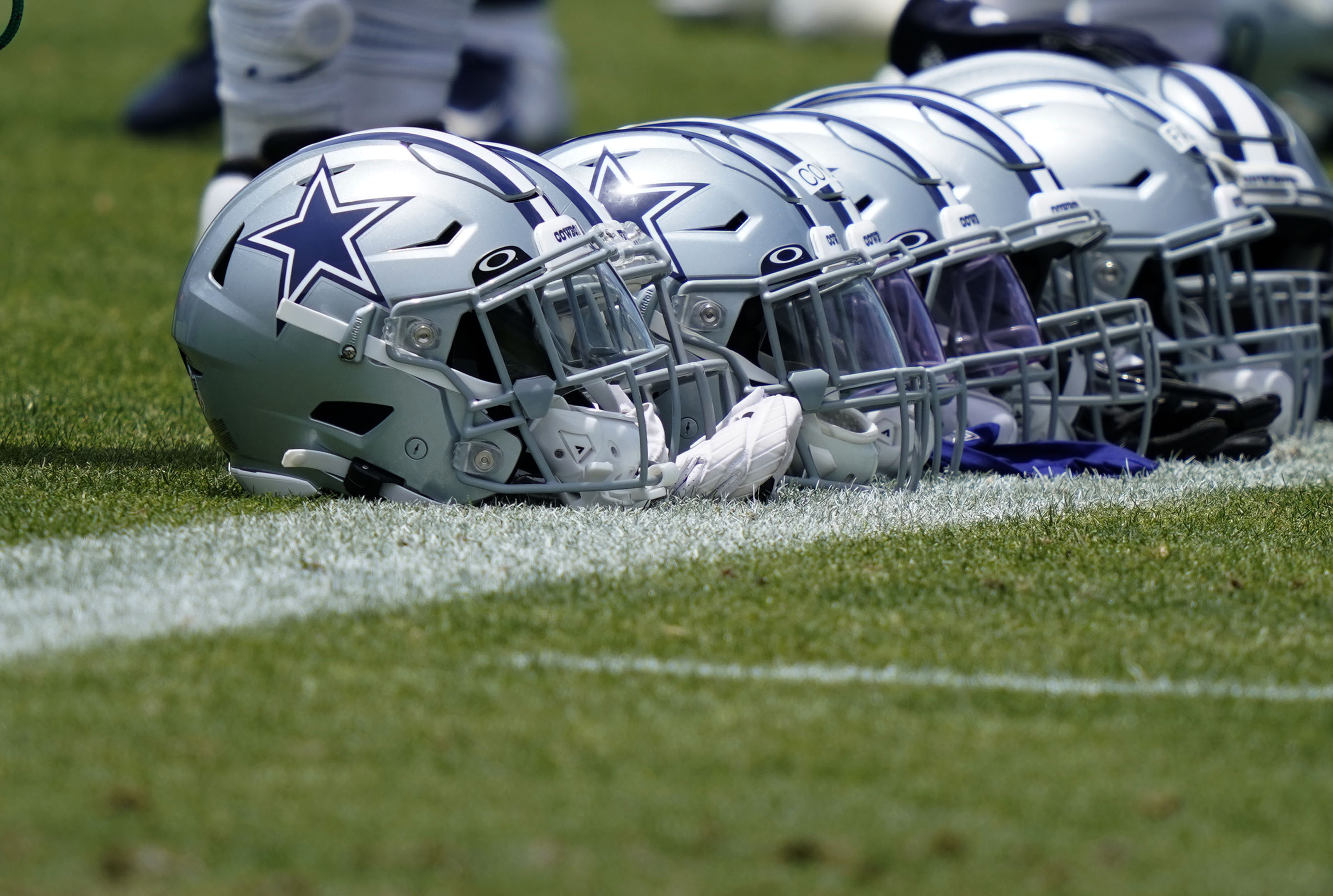 Dallas Cowboys helmets lines up during an NFL football team practice Tuesday, June 8, 2021, in Frisco, Texas. (AP Photo/LM Otero)