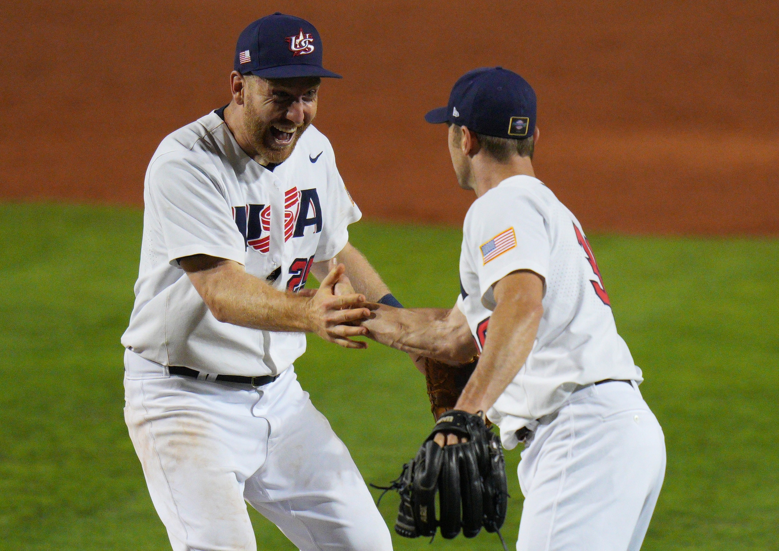 PORT ST. LUCIE, FLORIDA - JUNE 05: Todd Frazier #25 and David Robertson #30 of United States celebrate defeating Venezuela by score of 4-2 during the WBSC Baseball Americas Qualifier Super Round at Clover Park on June 05, 2021 in Port St. Lucie, Florida. (Photo by Mark Brown/Getty Images)