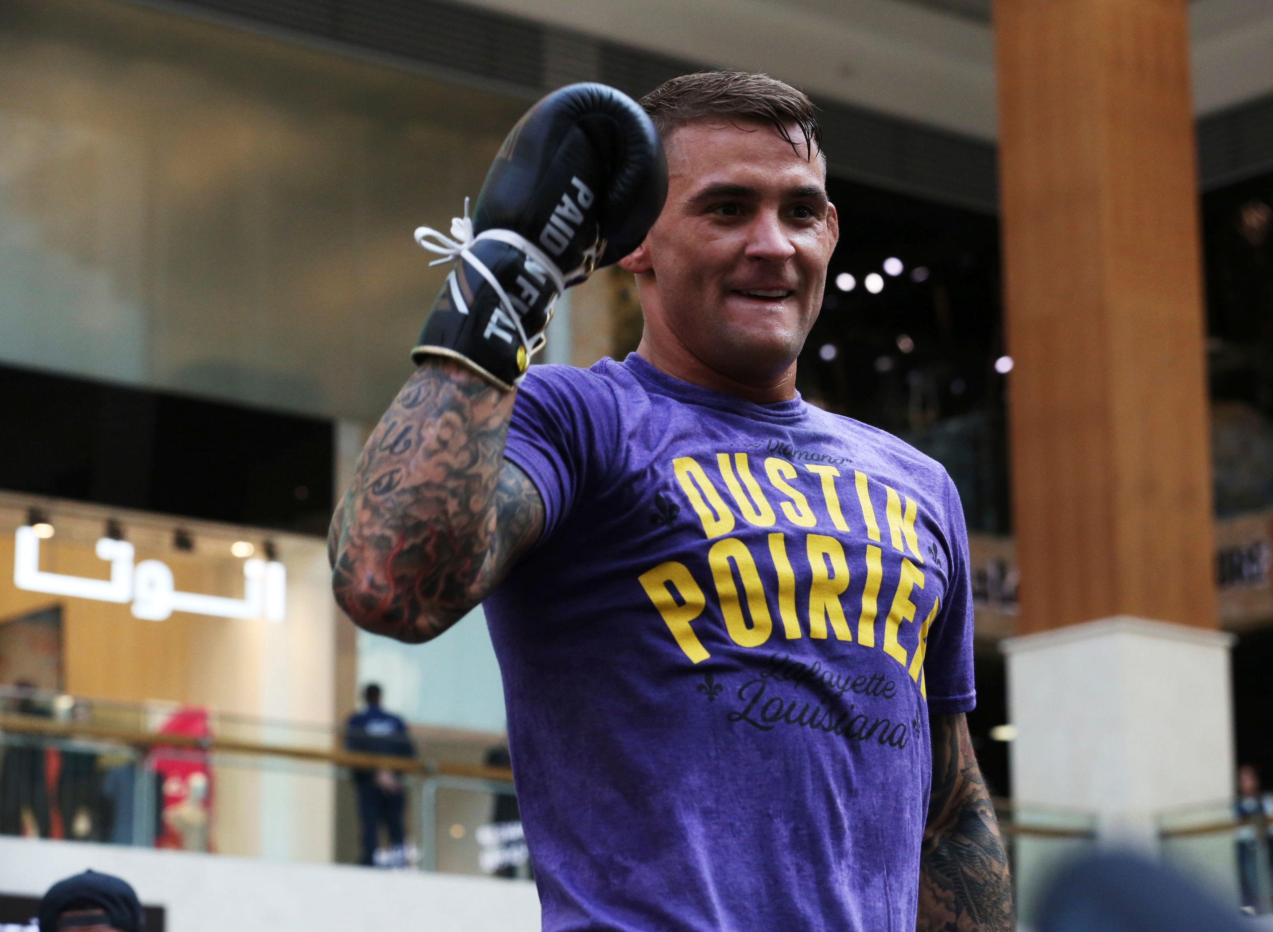 UFC fighter Dustin Poirier of Lafayette, Louisiana, gestures during an open training session at Yas Mall in Abu Dhabi, United Arab Emirates, Wednesday, Sept. 4, 2019. Fighters Dustin Poirier and Khabib Nurmagomedov will face each other in UFC 242, which will be held Saturday, Sept. 7, 2019, in Abu Dhabi. (AP Photo/Jon Gambrell)