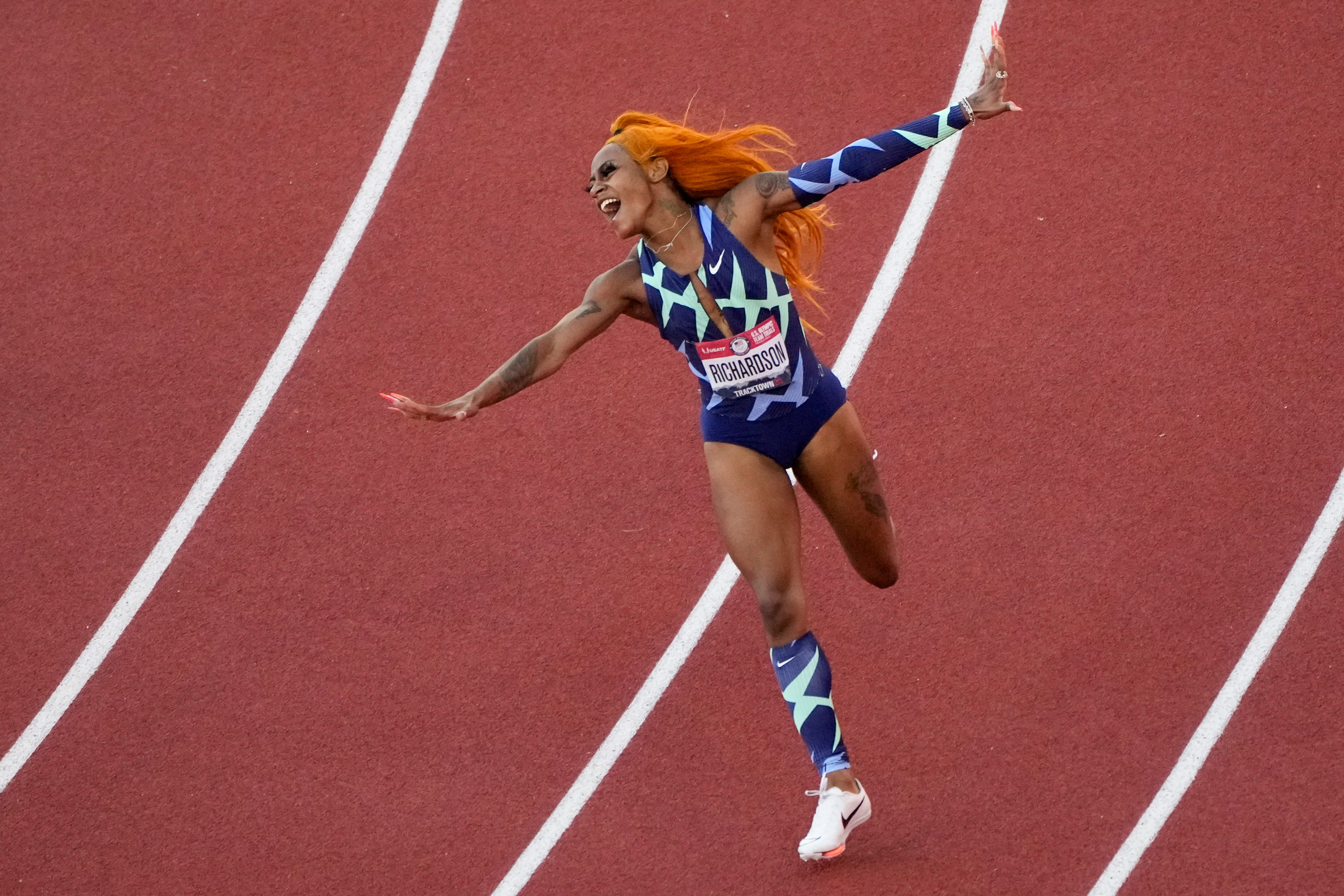 Sha'Carri Richardson celebrates after winning the women's 100-meter run at the U.S. Olympic Track and Field Trials Saturday, June 19, 2021, in Eugene, Ore.(AP Photo/Charlie Riedel)