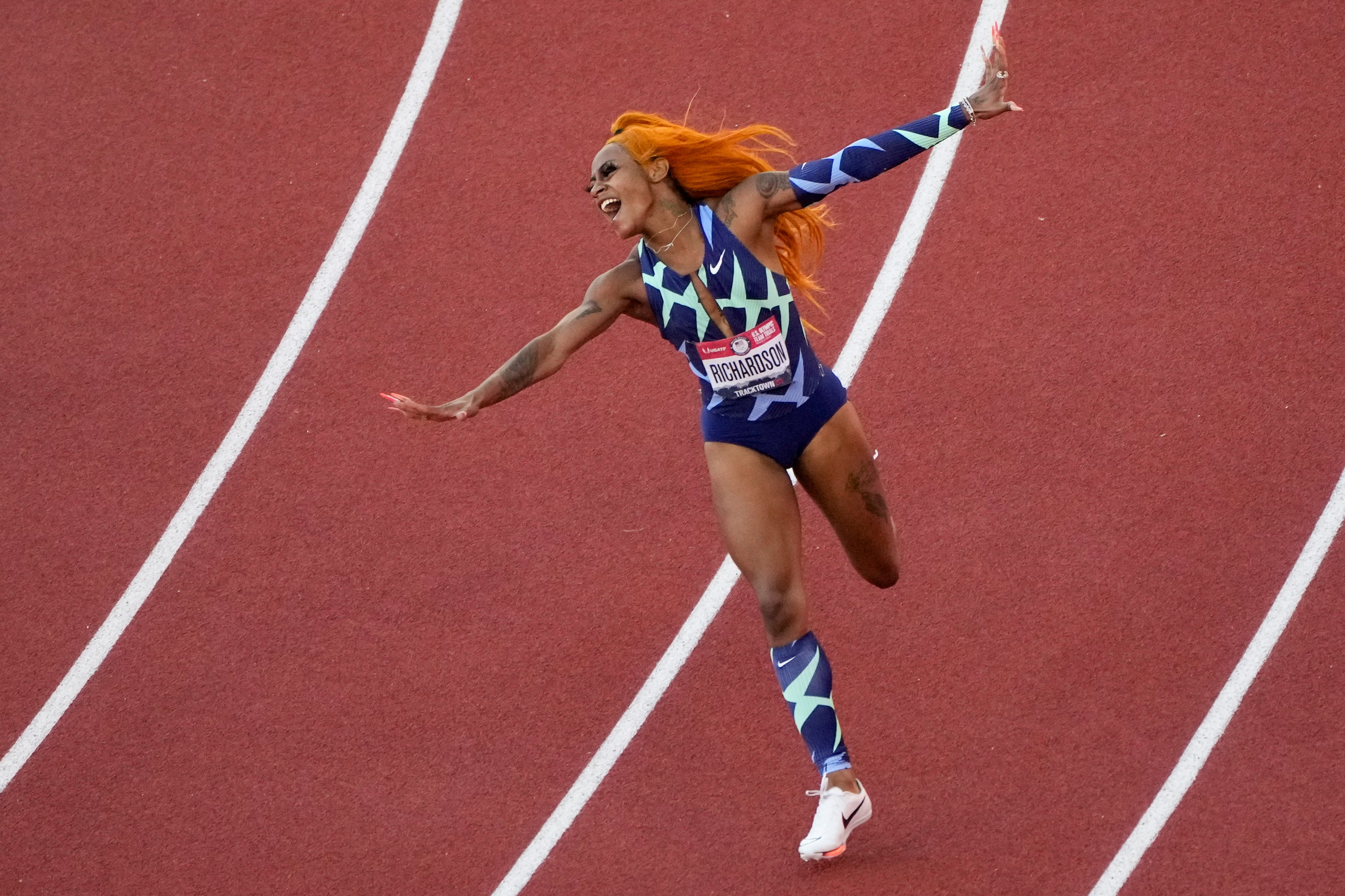 Sha'Carri Richardson celebrates after winning the women's 100-meter run at the U.S. Olympic Track and Field Trials Saturday, June 19, 2021, in Eugene, Ore.(AP Photo/Charlie Riedel)